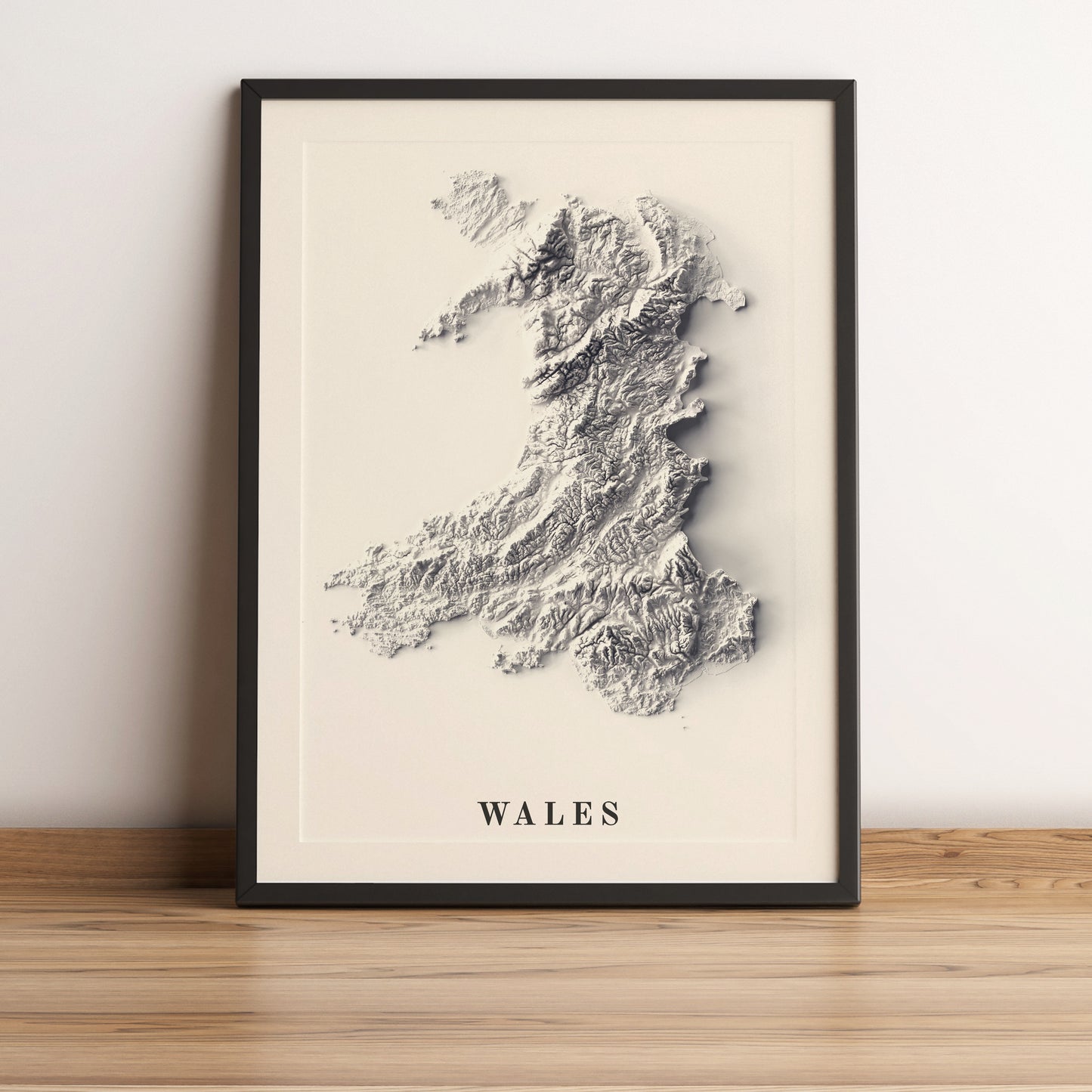 Wales framed shaded relief map in black frame. Artistic print highlighting mountains with a realistic terrain effect