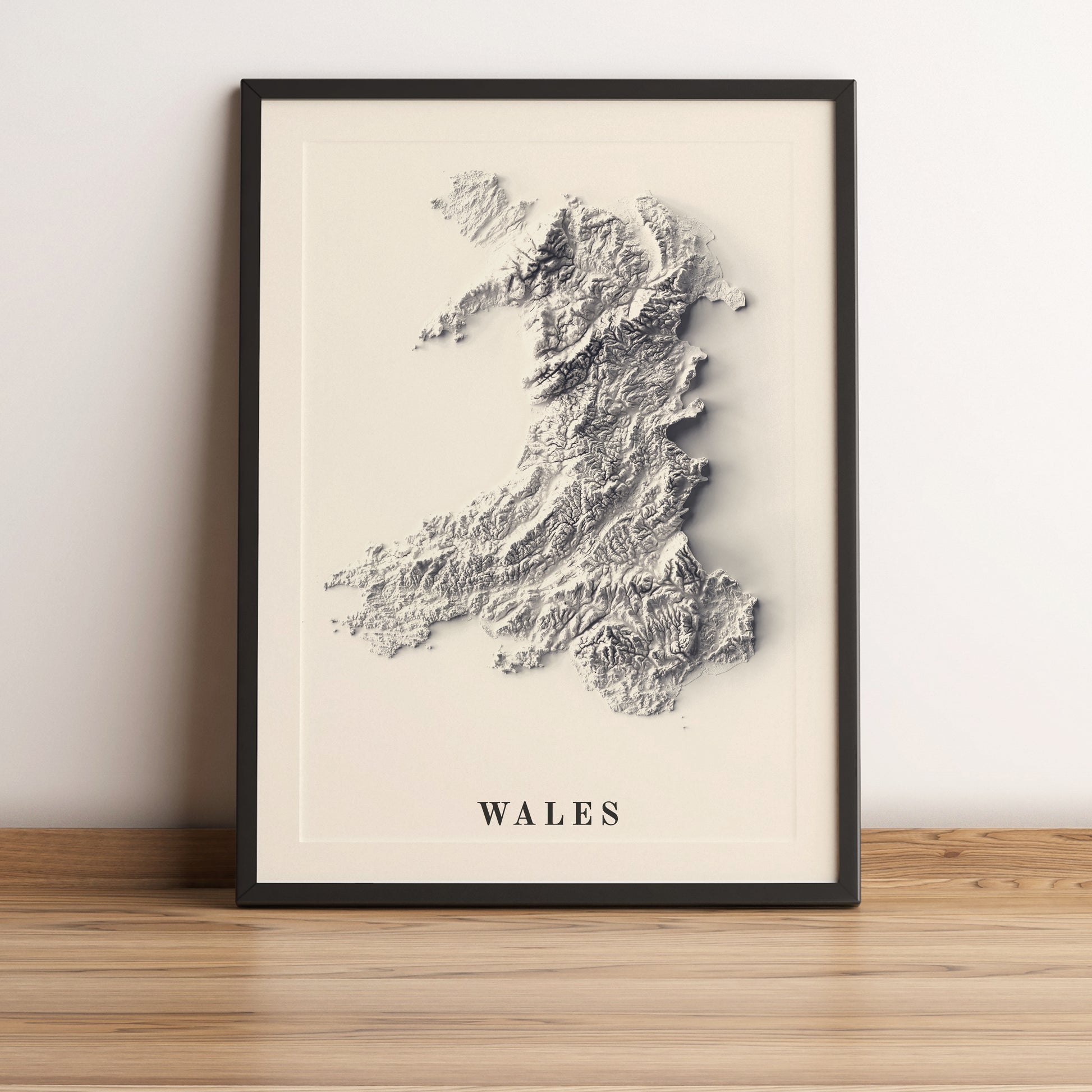 Wales framed shaded relief map in black frame. Artistic print highlighting mountains with a realistic terrain effect