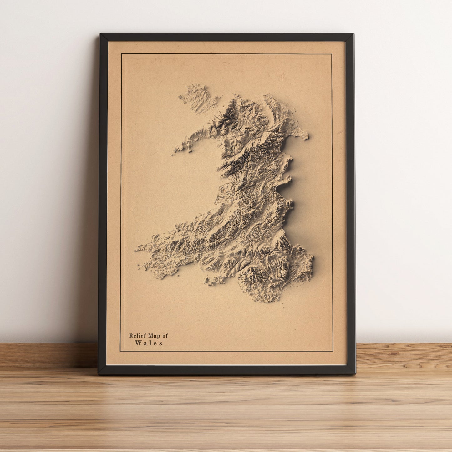 Wales framed shaded relief map in black frame. Artistic print highlighting mountains with a realistic terrain effect