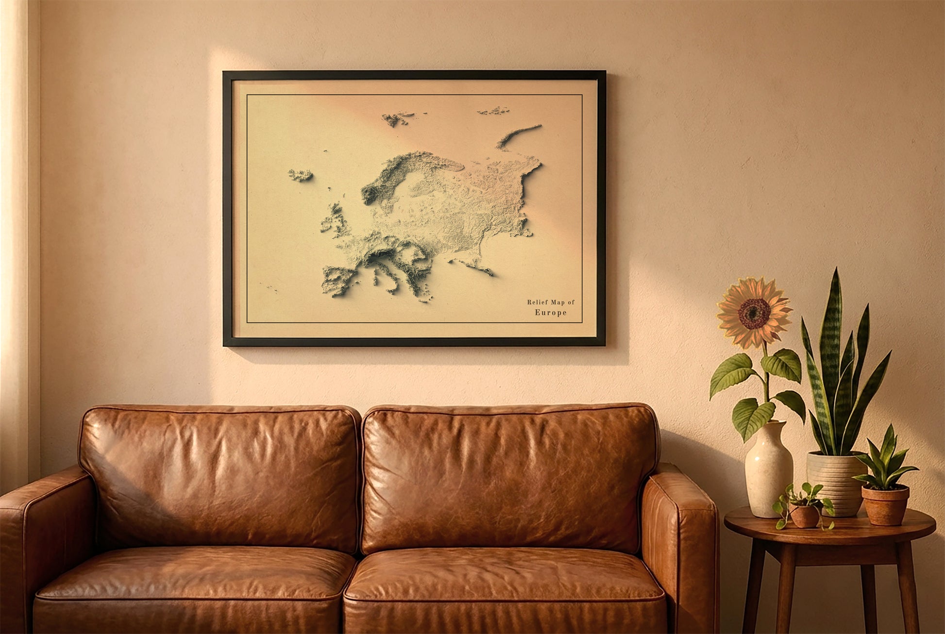 Europe vintage relief map in a black frame above a brown leather sofa. Boho living room with warm sunlight, sunflower, and indoor plants on a wooden side table