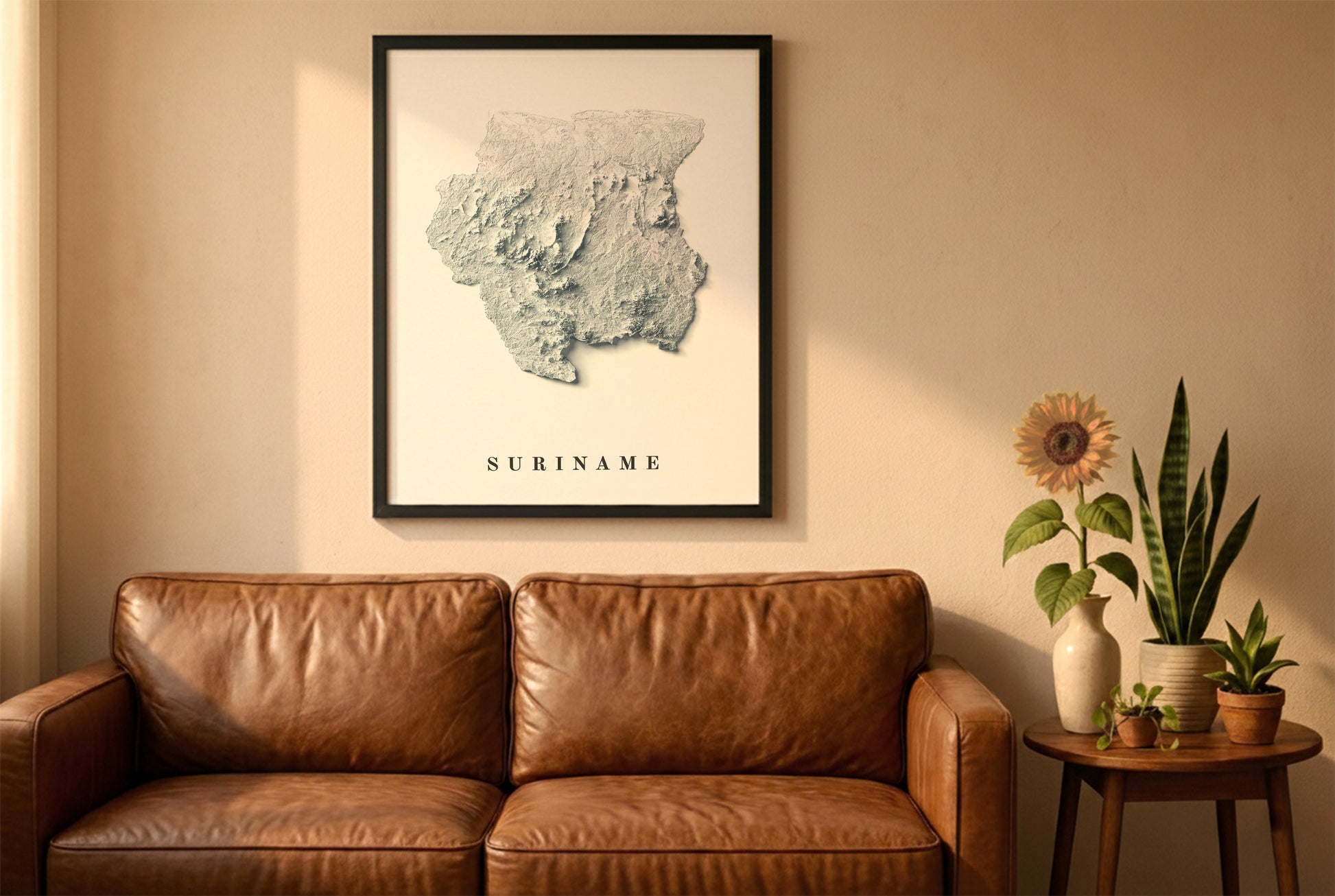 Suriname relief map in a black frame above a brown leather sofa. Boho living room with warm sunlight, sunflower, and indoor plants on a wooden side table