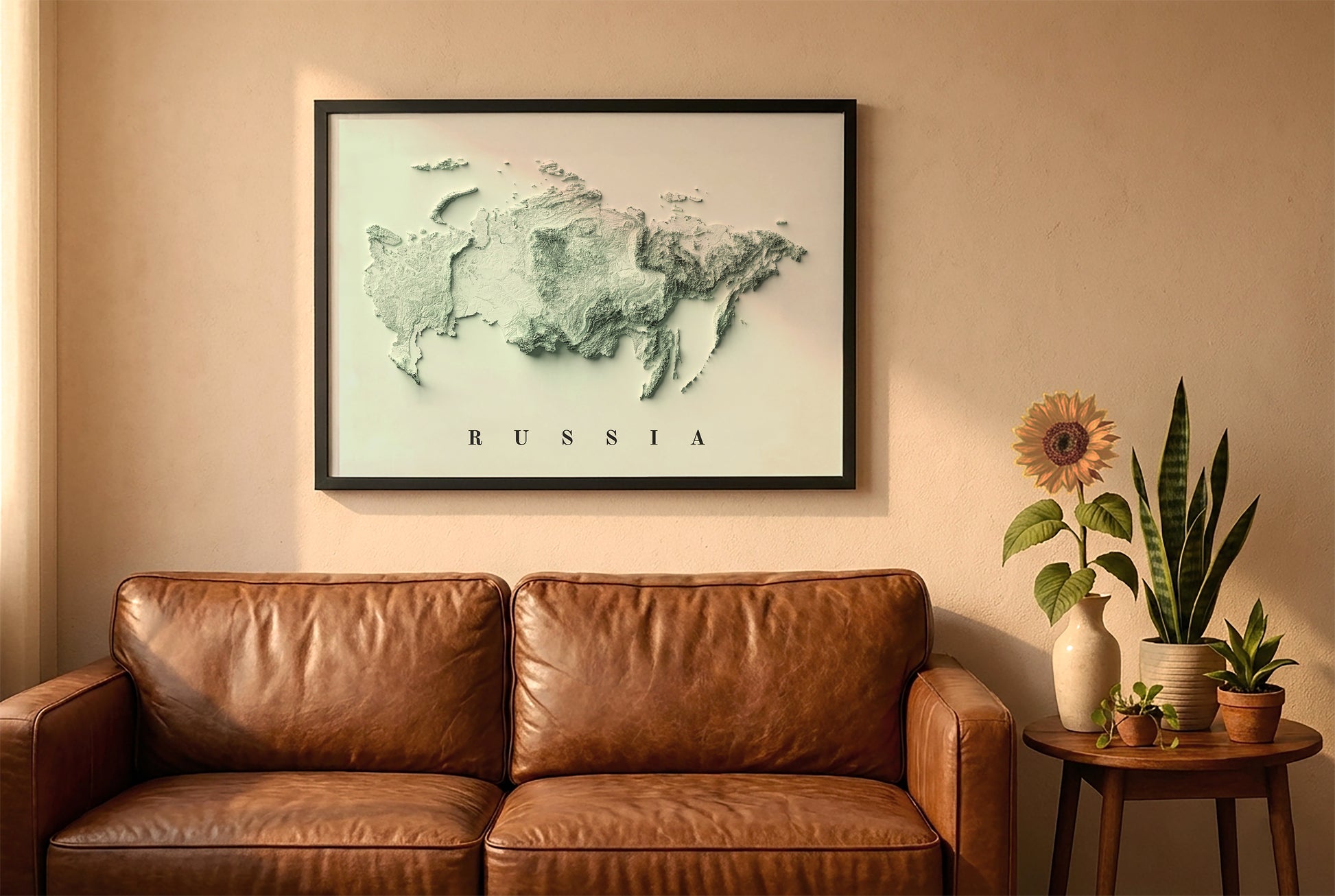 Russia relief map in a black frame above a brown leather sofa. Boho living room with warm sunlight, sunflower, and indoor plants on a wooden side table