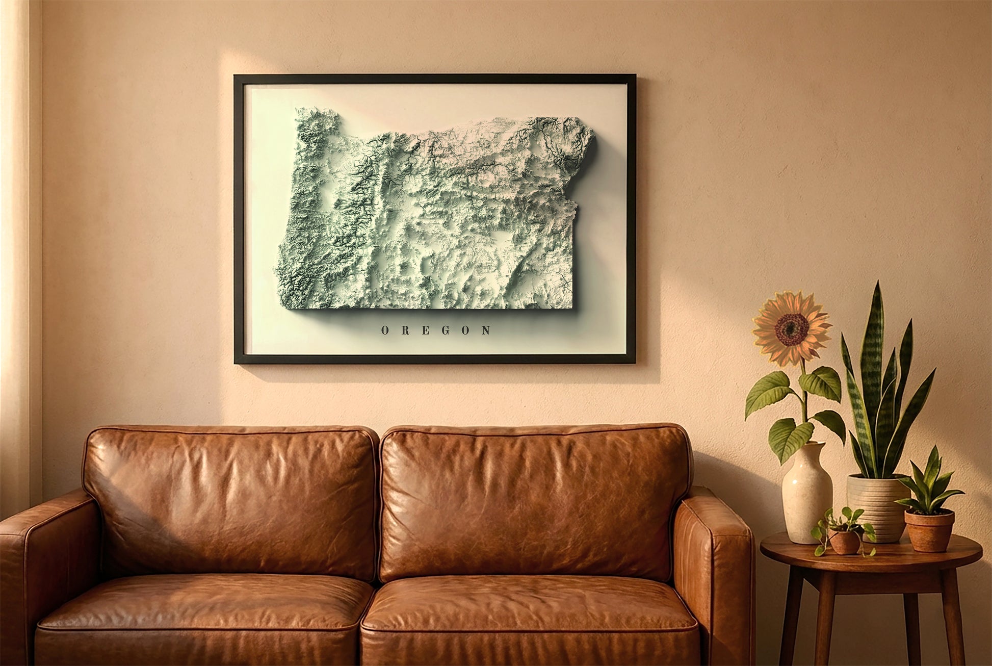 Oregon relief map in a black frame above a brown leather sofa. Boho living room with warm sunlight, sunflower, and indoor plants on a wooden side table