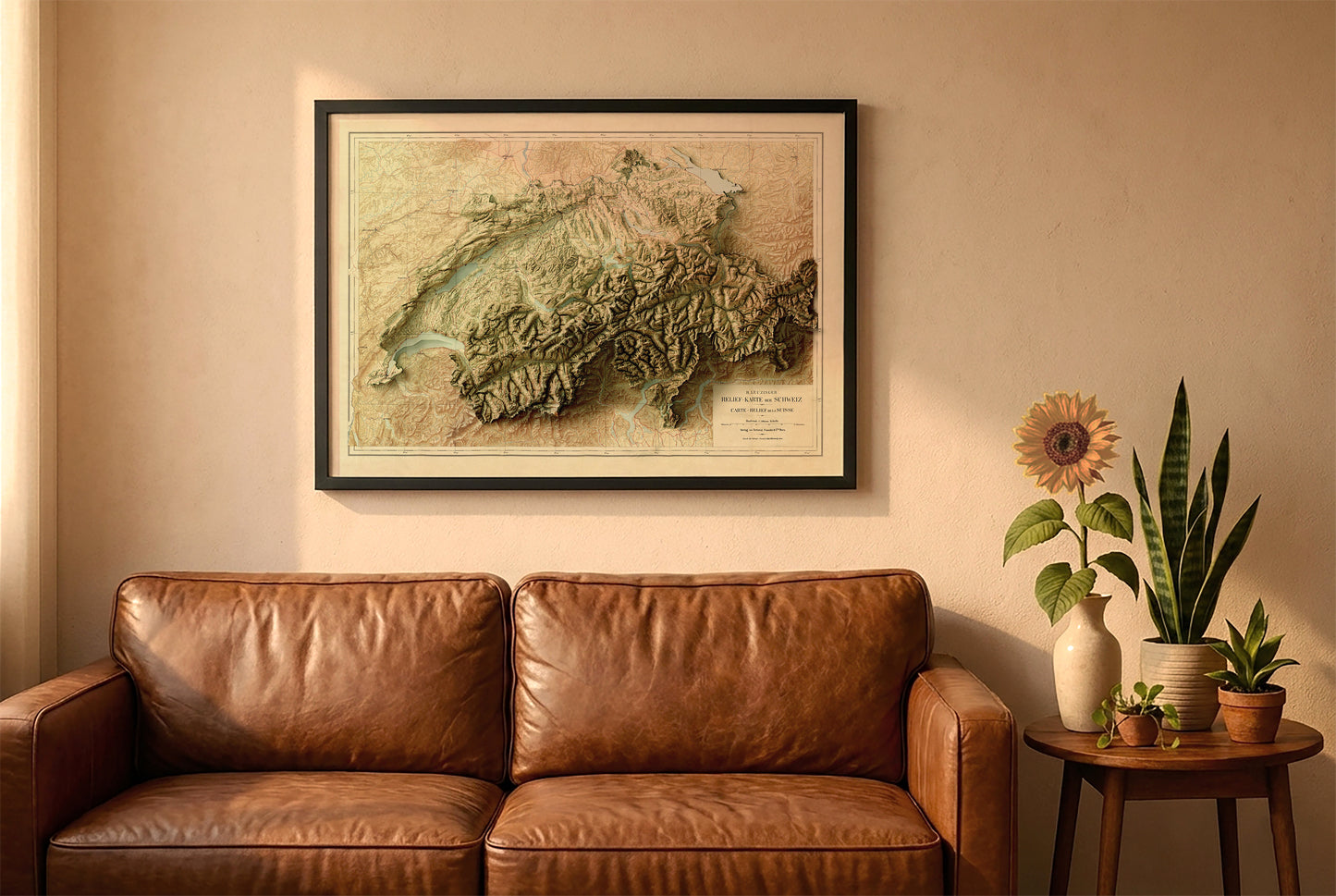 Switzerland vintage relief map in a black frame above a brown leather sofa. Boho living room with warm sunlight, sunflower, and indoor plants on a wooden side table