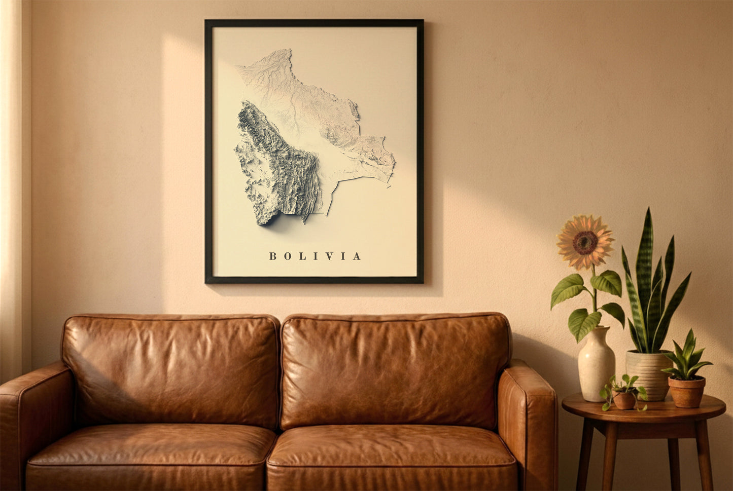 Bolivia relief map in a black frame above a brown leather sofa. Boho living room with warm sunlight, sunflower, and indoor plants on a wooden side table