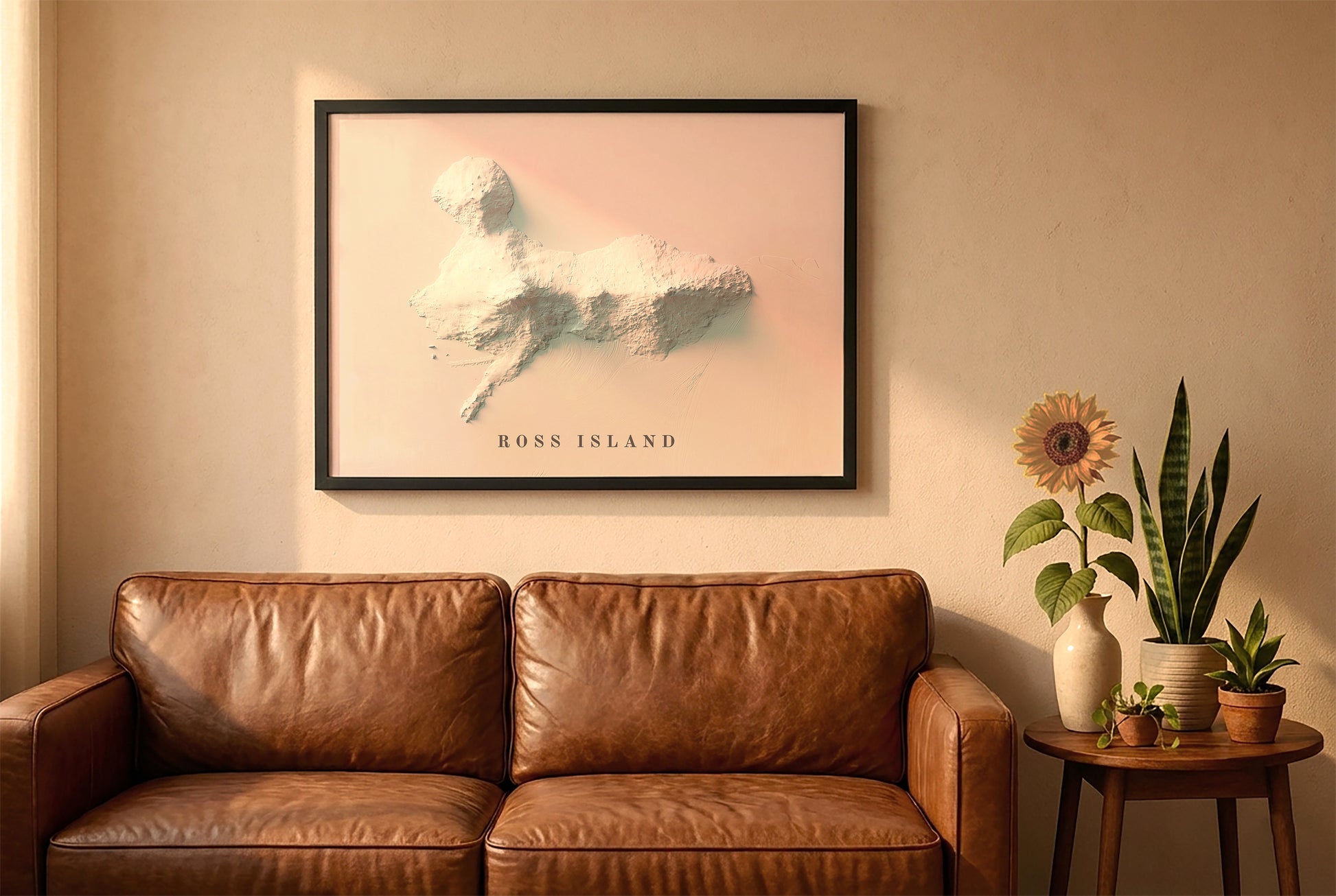 Ross Island, Antarctica, relief map in a black frame above a brown leather sofa. Boho living room with warm sunlight, sunflower, and indoor plants on a wooden side table