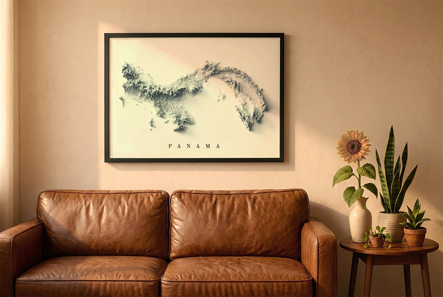 Panama relief map in a black frame above a brown leather sofa. Boho living room with warm sunlight, sunflower, and indoor plants on a wooden side table