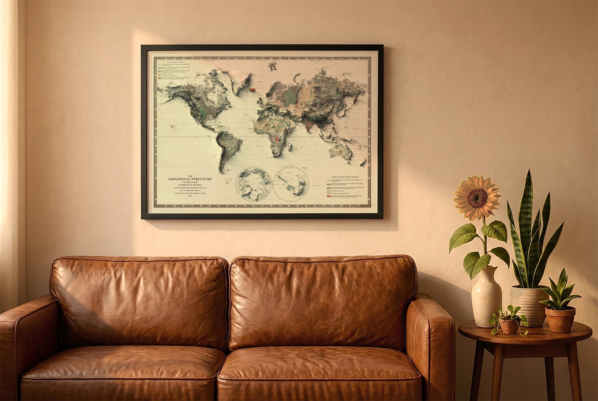 Vintage world relief map in a black frame above a brown leather sofa. Boho living room with warm sunlight, sunflower, and indoor plants on a wooden side table