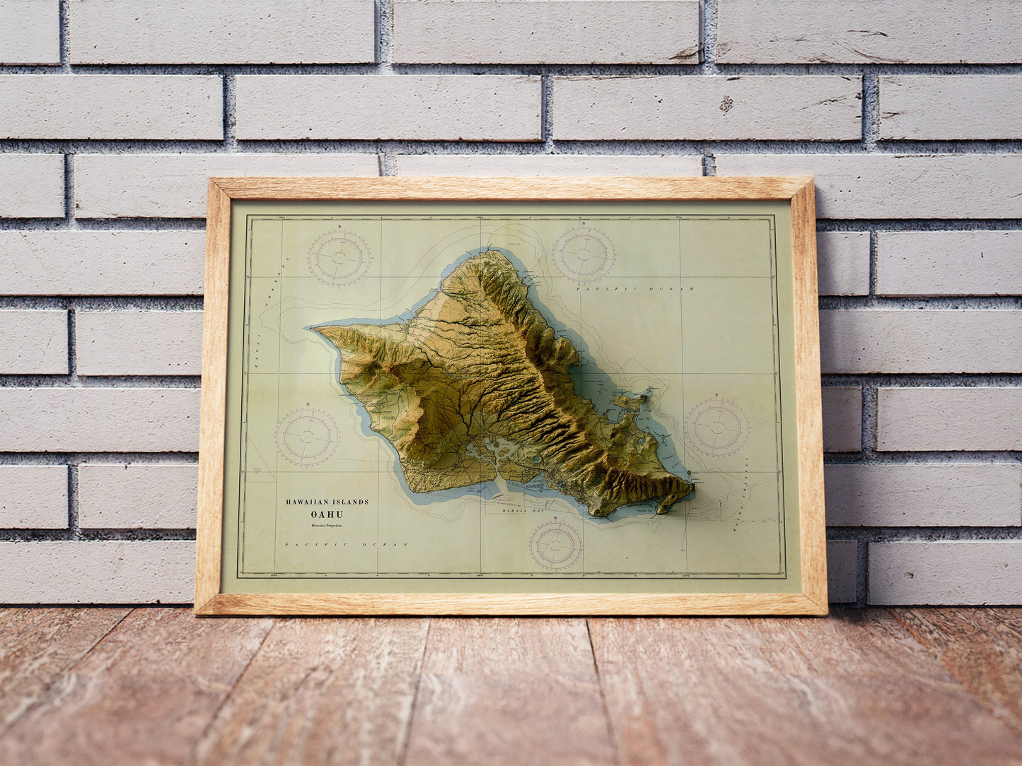 Vintage Oahu, Hawaii, shaded relief map in a wooden frame. Realistic terrain art print for home decor, displayed against a brick wall