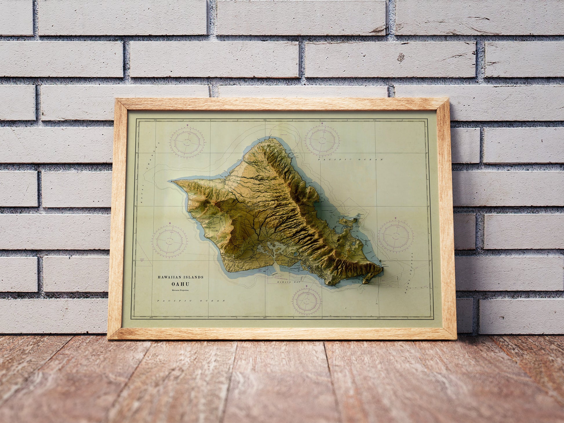 Vintage Oahu, Hawaii, shaded relief map in a wooden frame. Realistic terrain art print for home decor, displayed against a brick wall