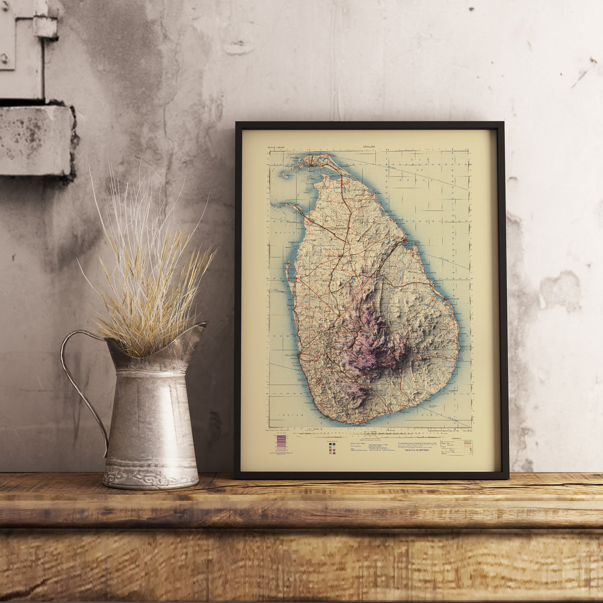 Vintage Sri Lanka shaded relief map in black frame. Realistic terrain art print for home decor, displayed on rustic wooden table