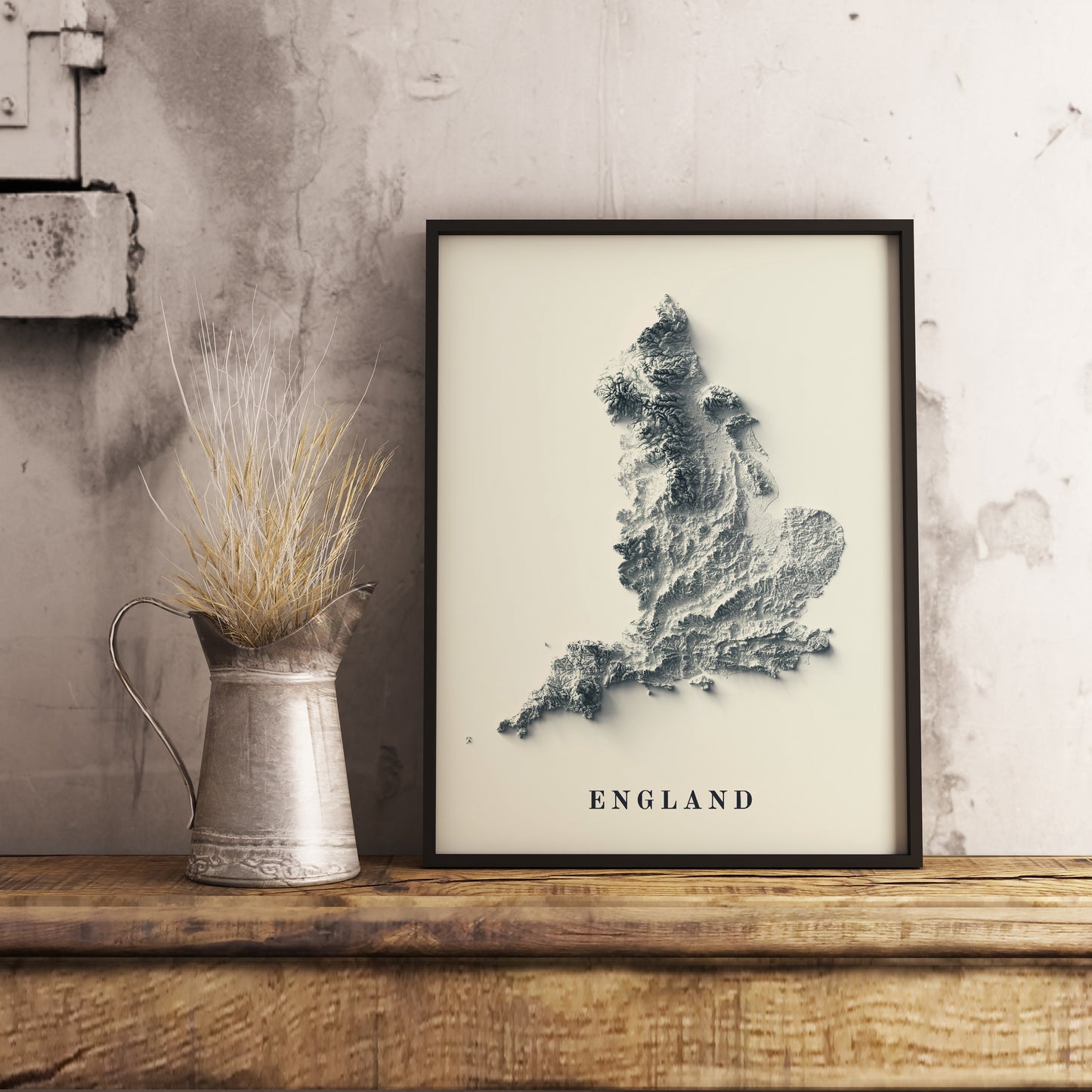 England shaded relief map in black frame. Realistic terrain art print for home decor, displayed on rustic wooden table