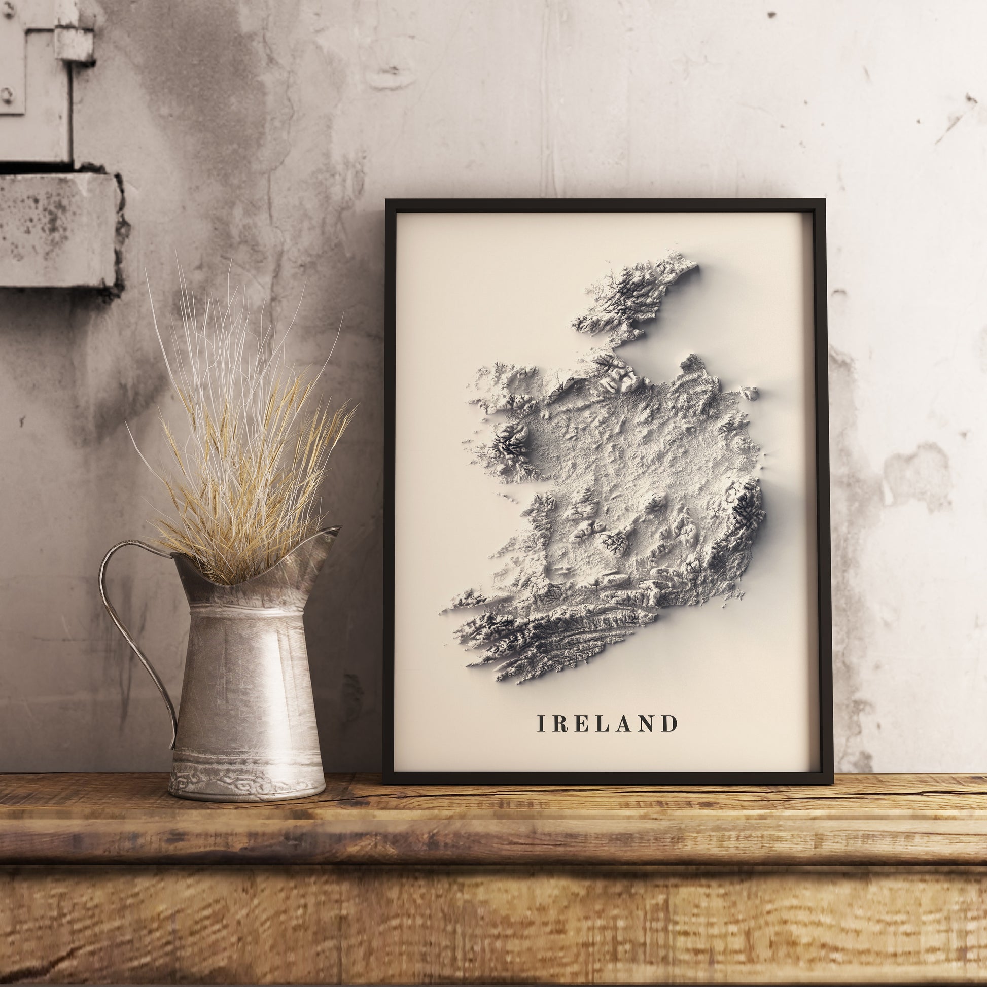 Ireland shaded relief map in black frame. Realistic terrain art print for home decor, displayed on rustic wooden table