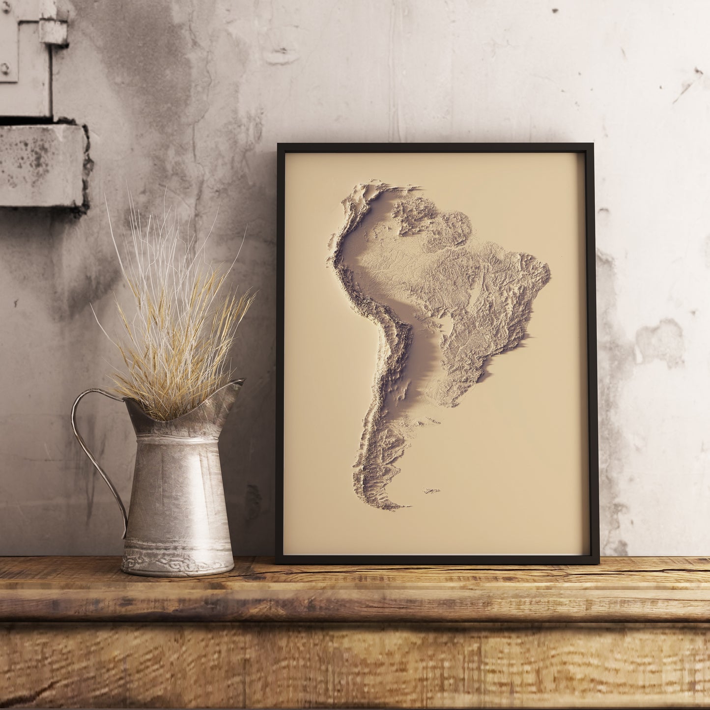 South America shaded relief map in black frame. Realistic terrain art print for home decor, displayed on rustic wooden table