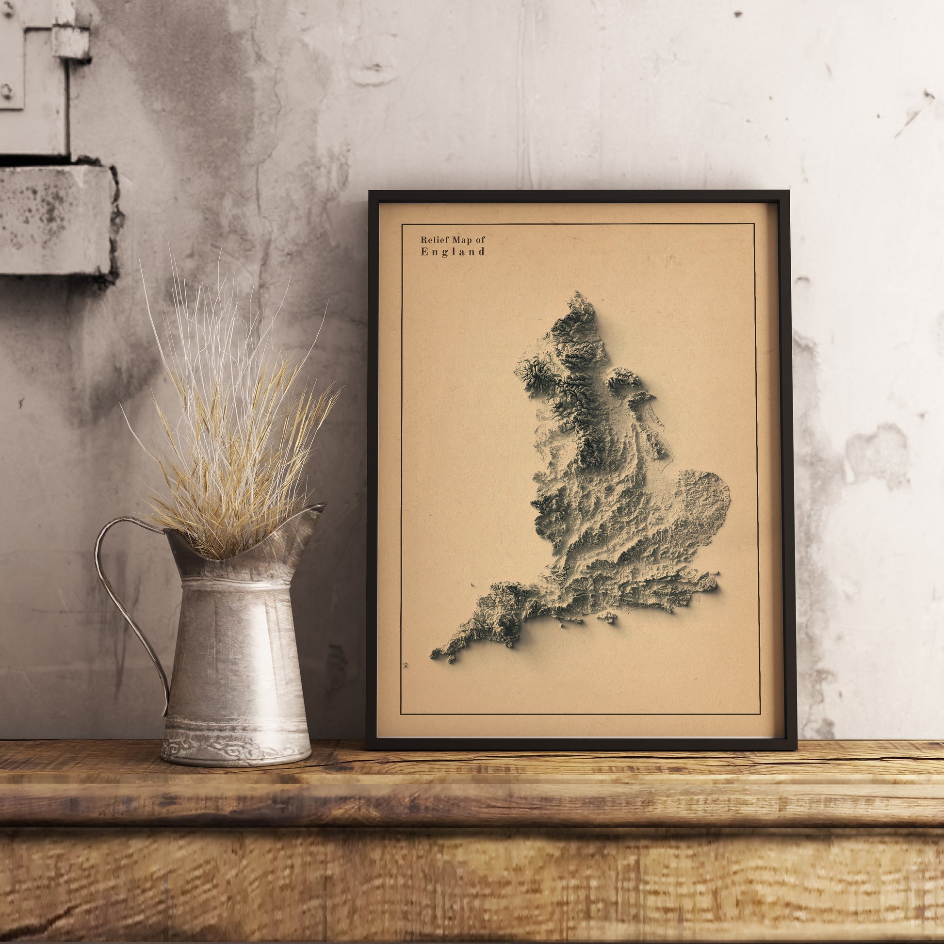 England shaded relief map in black frame. Realistic terrain art print for home decor, displayed on rustic wooden table