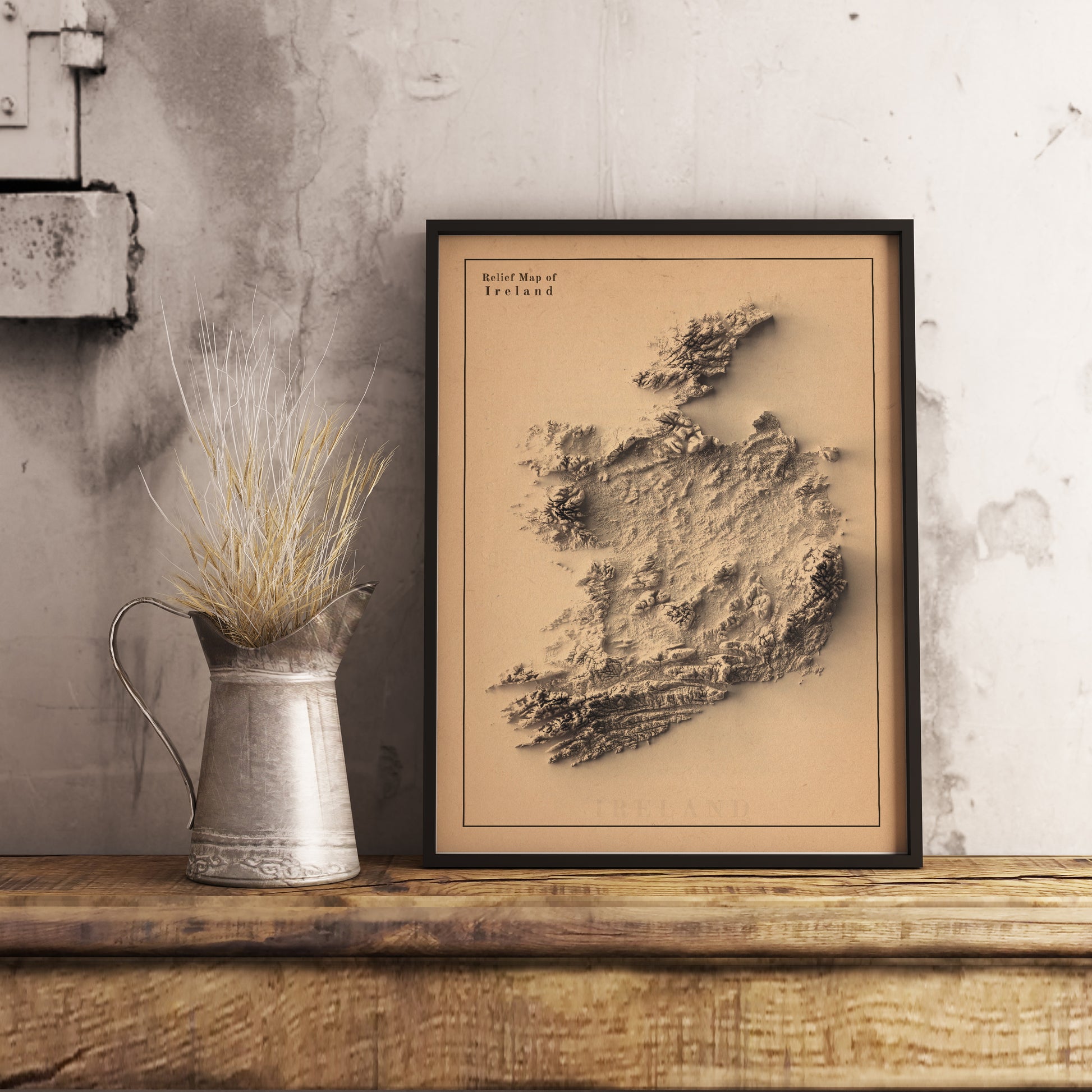 Ireland shaded relief map in black frame. Realistic terrain art print for home decor, displayed on rustic wooden table.