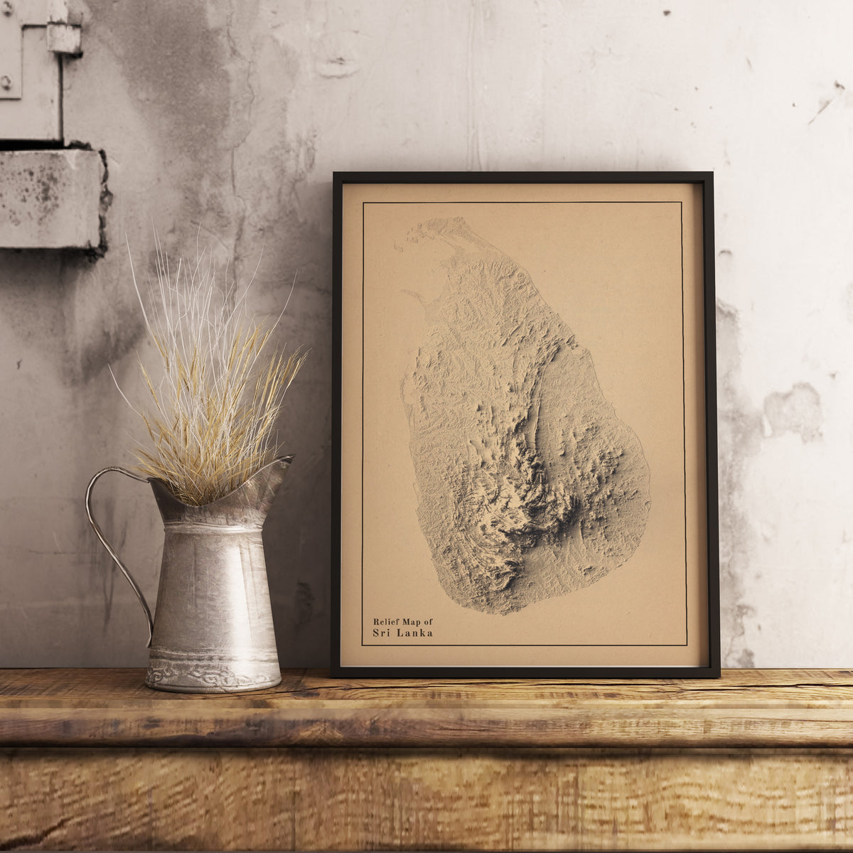 Vintage Sri Lanka shaded relief map in black frame. Realistic terrain art print for home decor, displayed on rustic wooden table