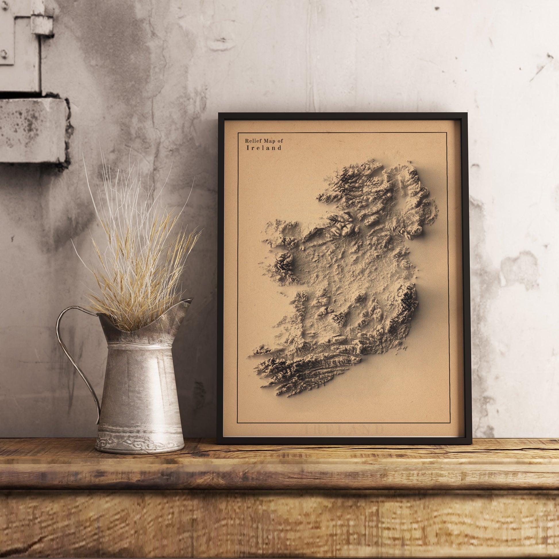 Ireland shaded relief map in black frame. Realistic terrain art print for home decor, displayed on rustic wooden table