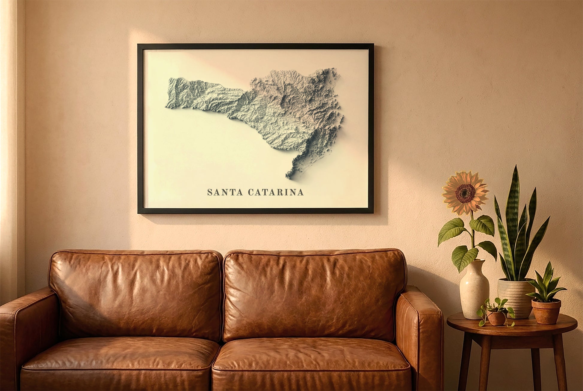Santa Catarina, Brazil, relief map in a black frame above a brown leather sofa. Boho living room with warm sunlight, sunflower, and indoor plants on a wooden side table