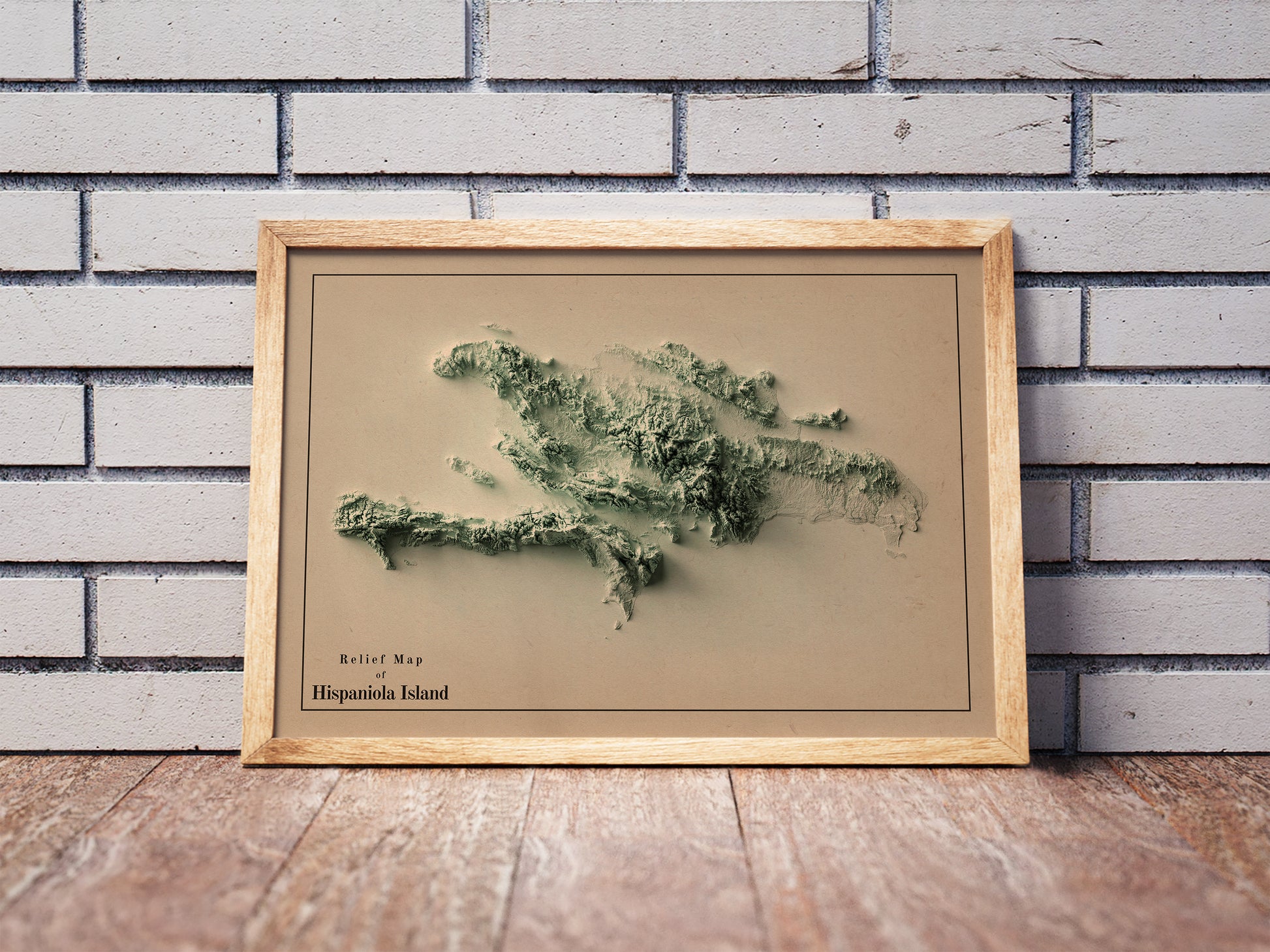 Vintage Hispaniola Island shaded relief map in a wooden frame. Realistic terrain art print for home decor, displayed against a brick wall