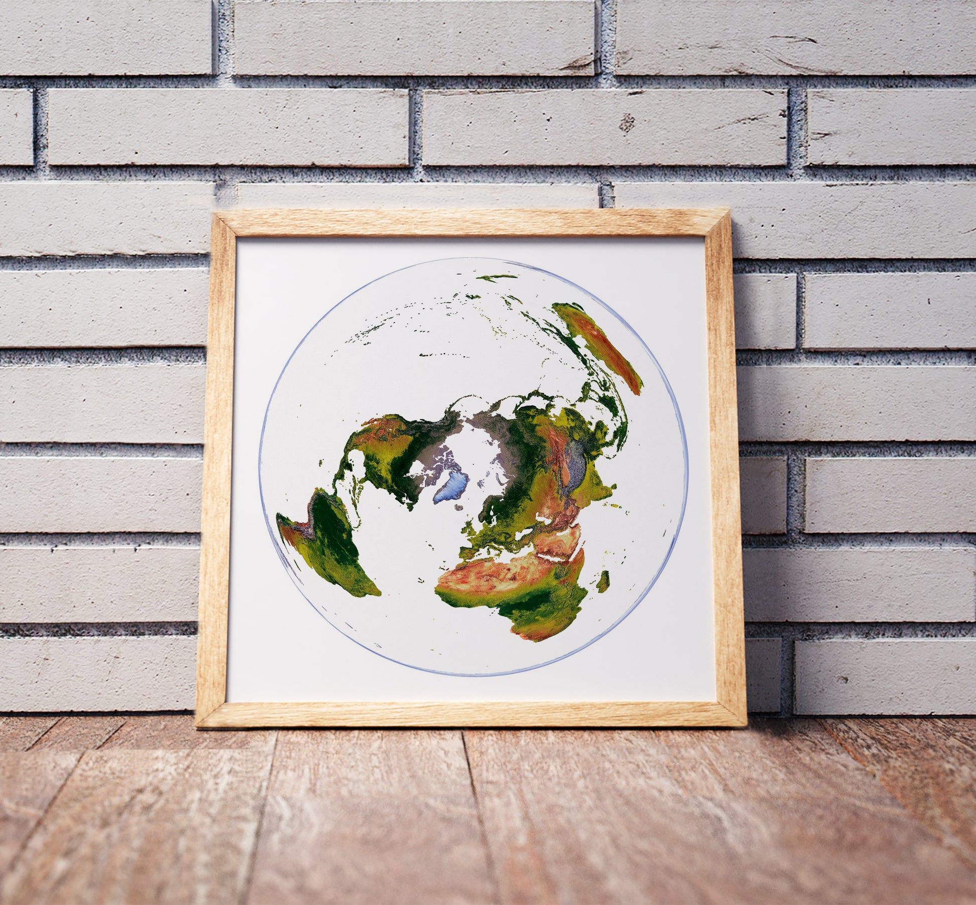 WGS 1984 Grid North projection shaded relief world map in a wooden frame. Realistic terrain art print for home decor, displayed against a brick wall