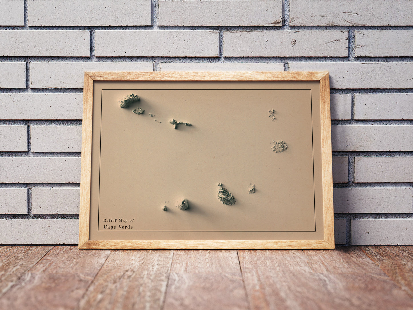 Vintage Cape Verde shaded relief map in a wooden frame. Realistic terrain art print for home decor, displayed against a brick wall