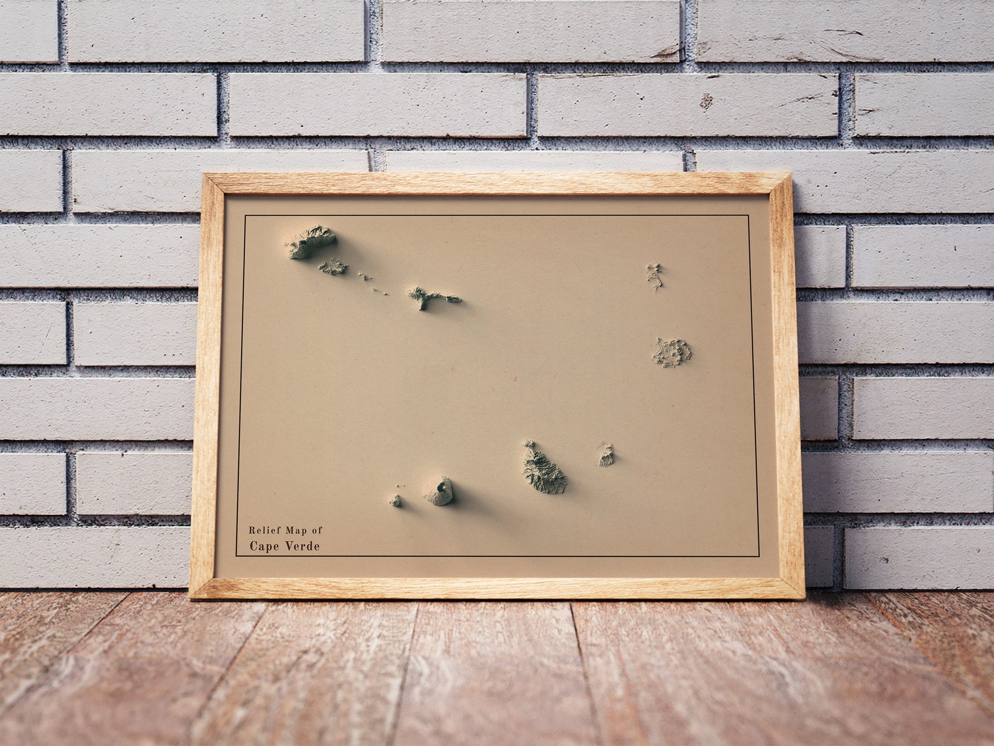 Vintage Cape Verde shaded relief map in a wooden frame. Realistic terrain art print for home decor, displayed against a brick wall