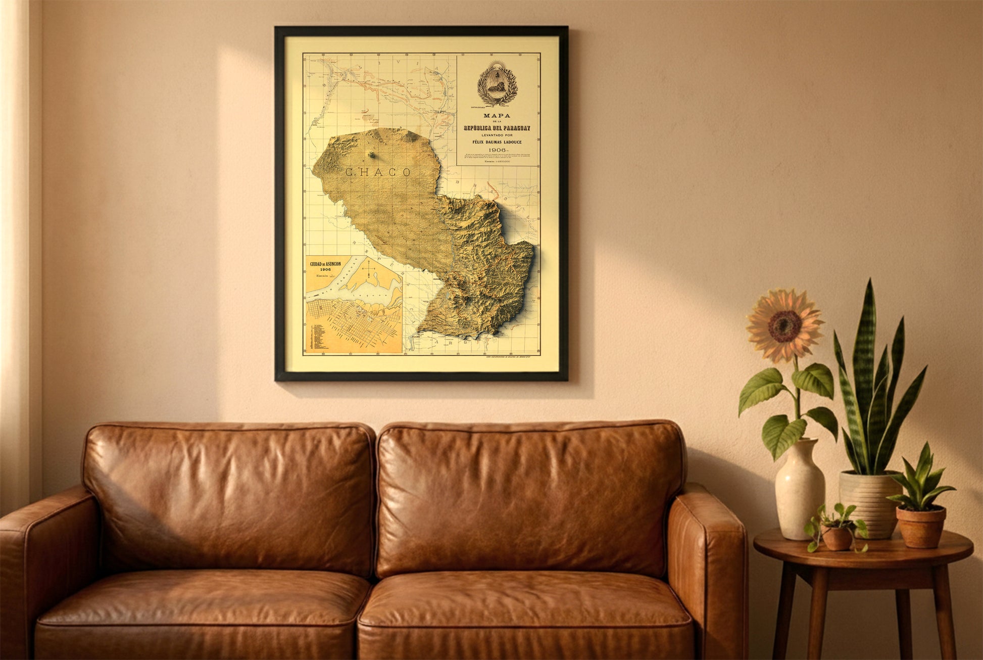 Paraguay vintage relief map in a black frame above a brown leather sofa. Boho living room with warm sunlight, sunflower, and indoor plants on a wooden side table