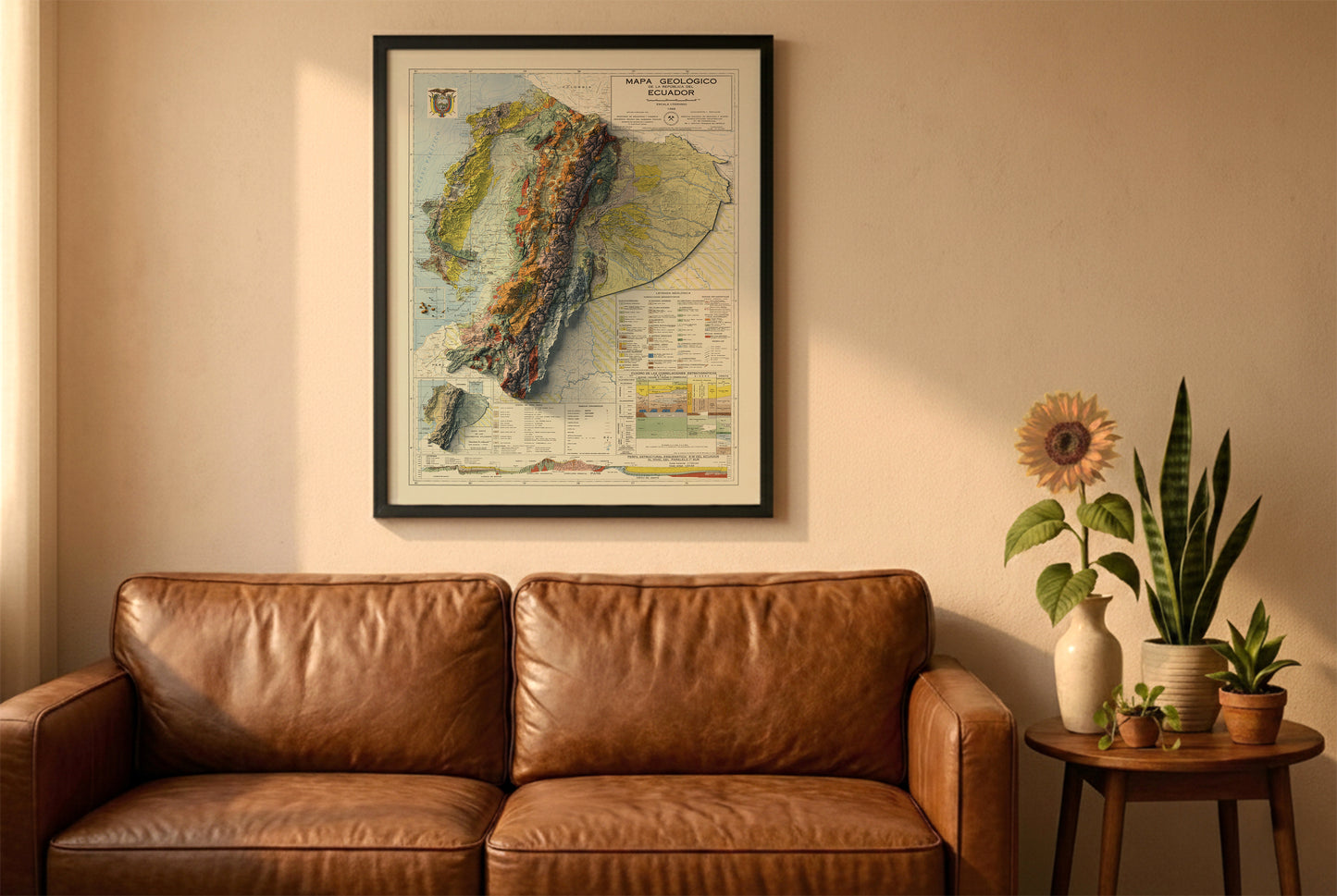 Ecuador vintage relief map in a black frame above a brown leather sofa. Boho living room with warm sunlight, sunflower, and indoor plants on a wooden side table