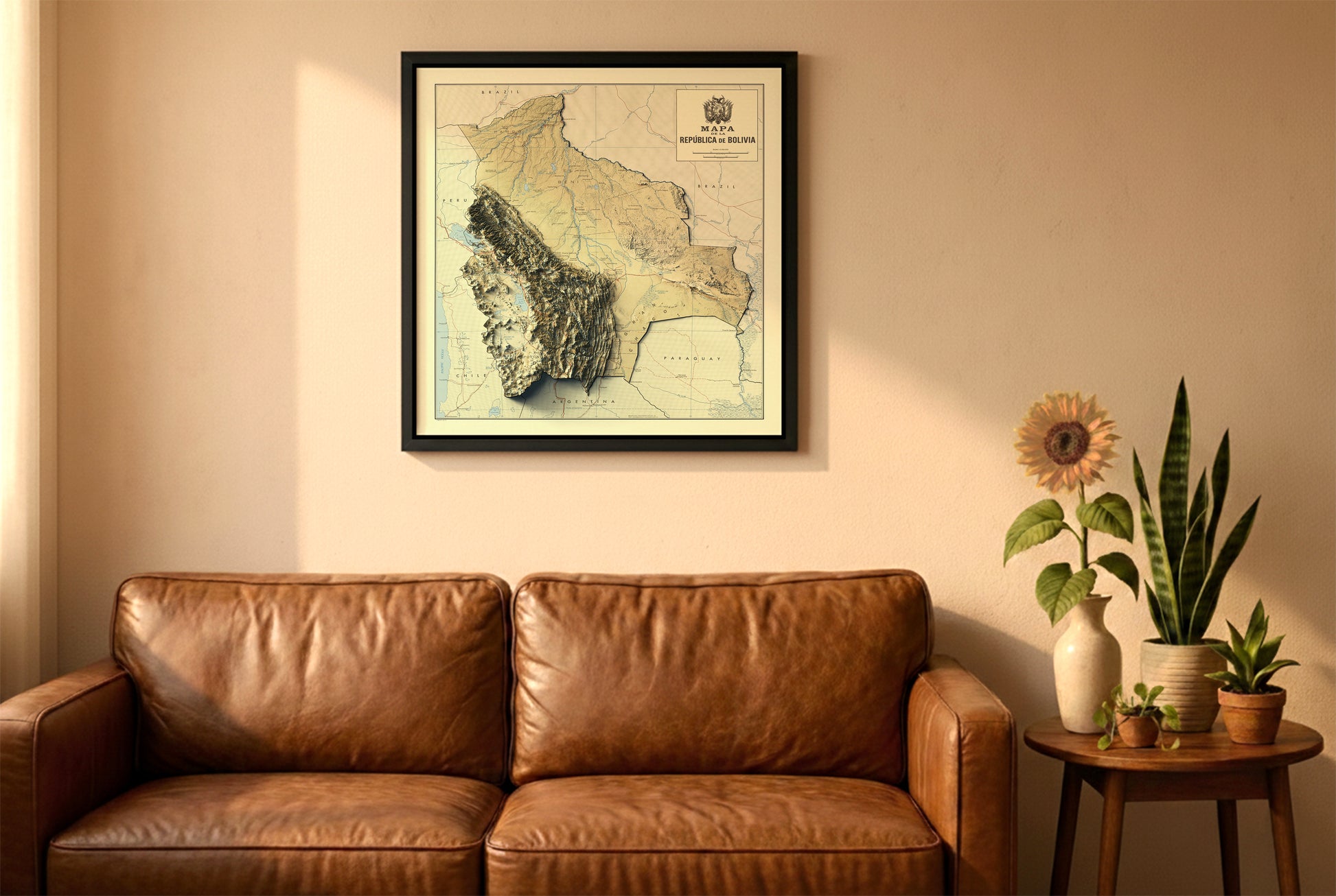 Bolivia vintage relief map in a black frame above a brown leather sofa. Boho living room with warm sunlight, sunflower, and indoor plants on a wooden side table