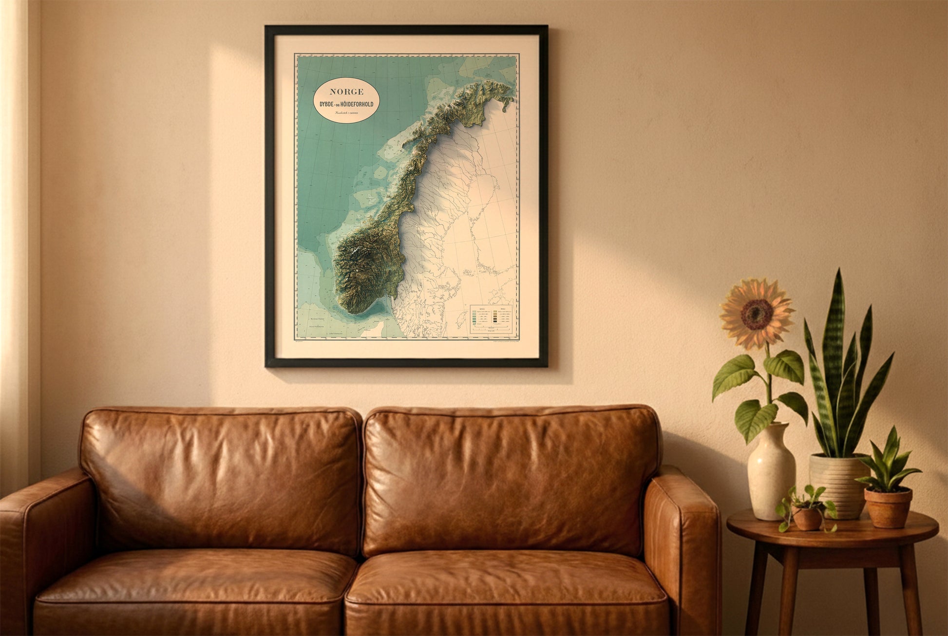 Norway vintage relief map in a black frame above a brown leather sofa. Boho living room with warm sunlight, sunflower, and indoor plants on a wooden side table