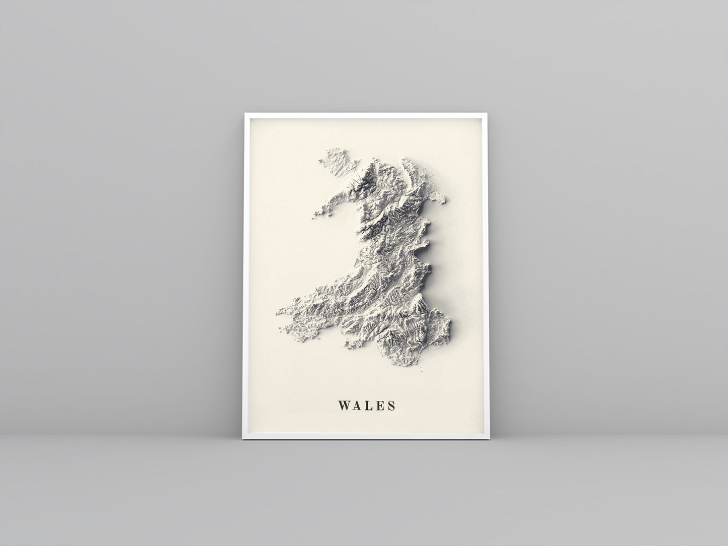 wales framed shaded relief map in white frame. Artistic print highlighting mountains with a realistic 3d effect