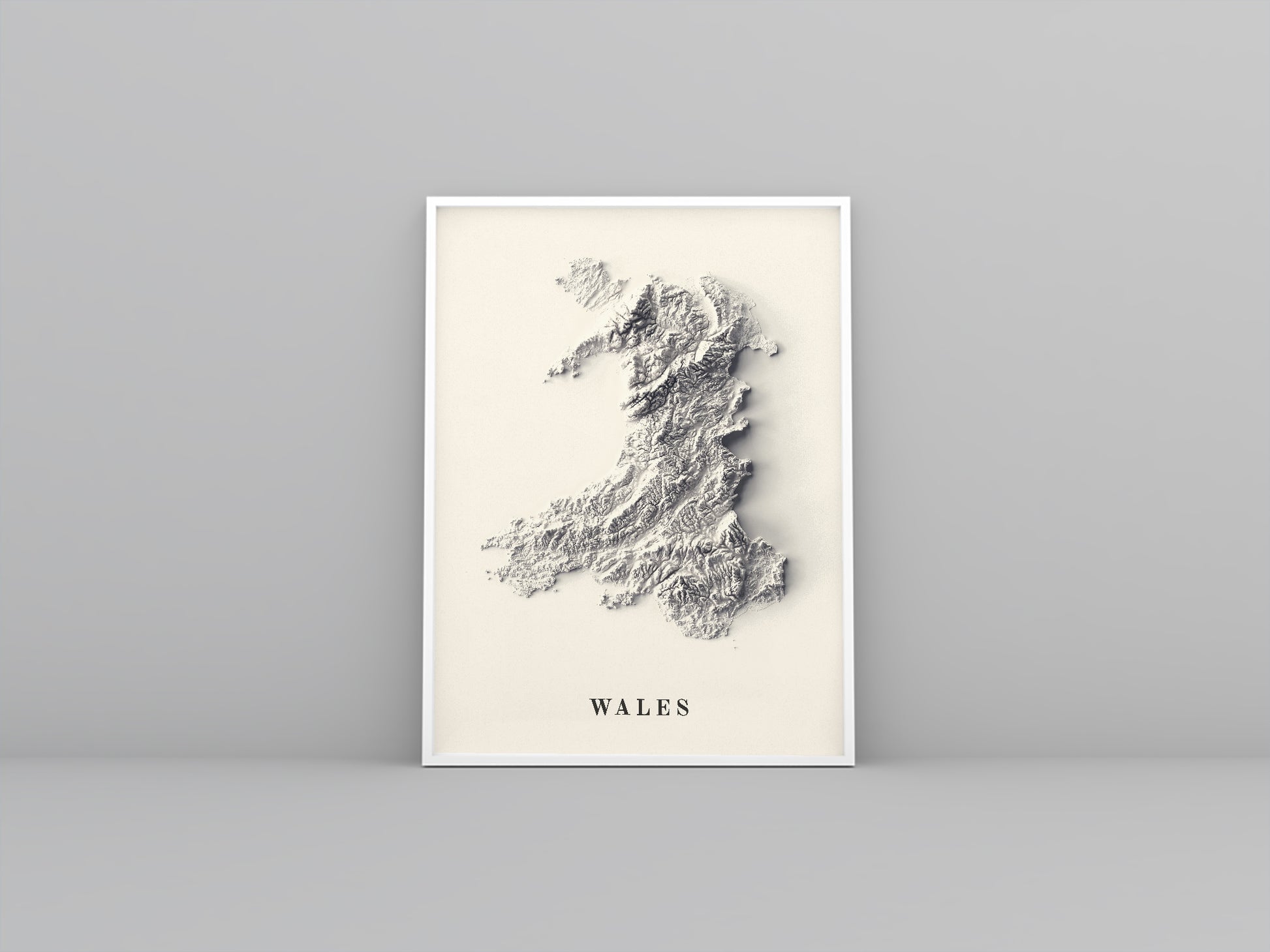 wales framed shaded relief map in white frame. Artistic print highlighting mountains with a realistic 3d effect