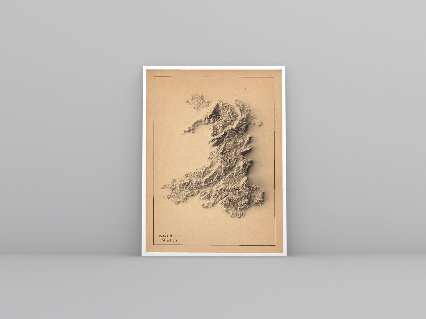 wales framed shaded relief map in white frame. Artistic print highlighting mountains with a realistic 3d effect