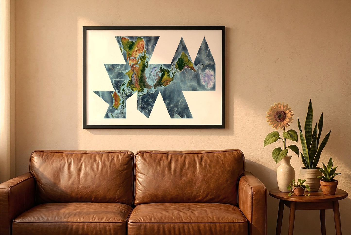 World relief map in fuller projection in a black frame above a brown leather sofa. Boho living room with warm sunlight, sunflower, and indoor plants on a wooden side table
