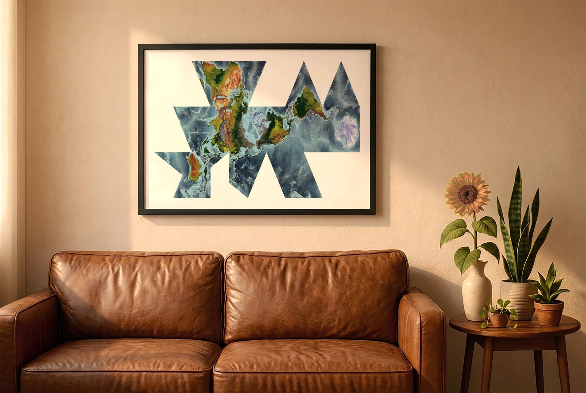 World relief map in fuller projection in a black frame above a brown leather sofa. Boho living room with warm sunlight, sunflower, and indoor plants on a wooden side table