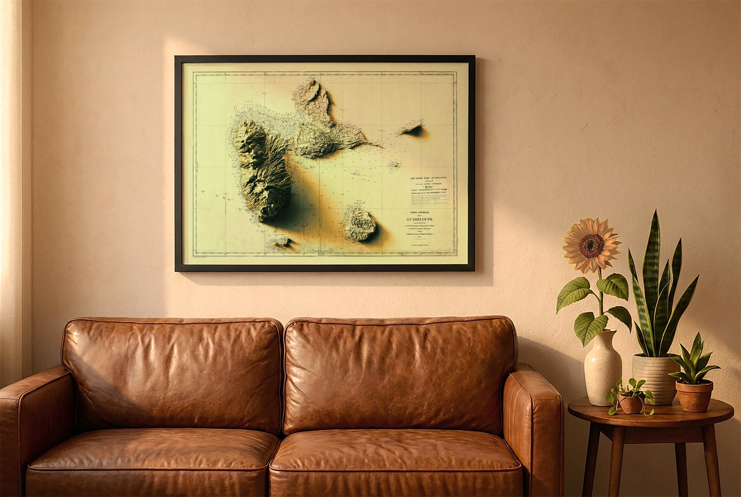 Guadeloupe, France, vintage relief map in a black frame above a brown leather sofa. Boho living room with warm sunlight, sunflower, and indoor plants on a wooden side table