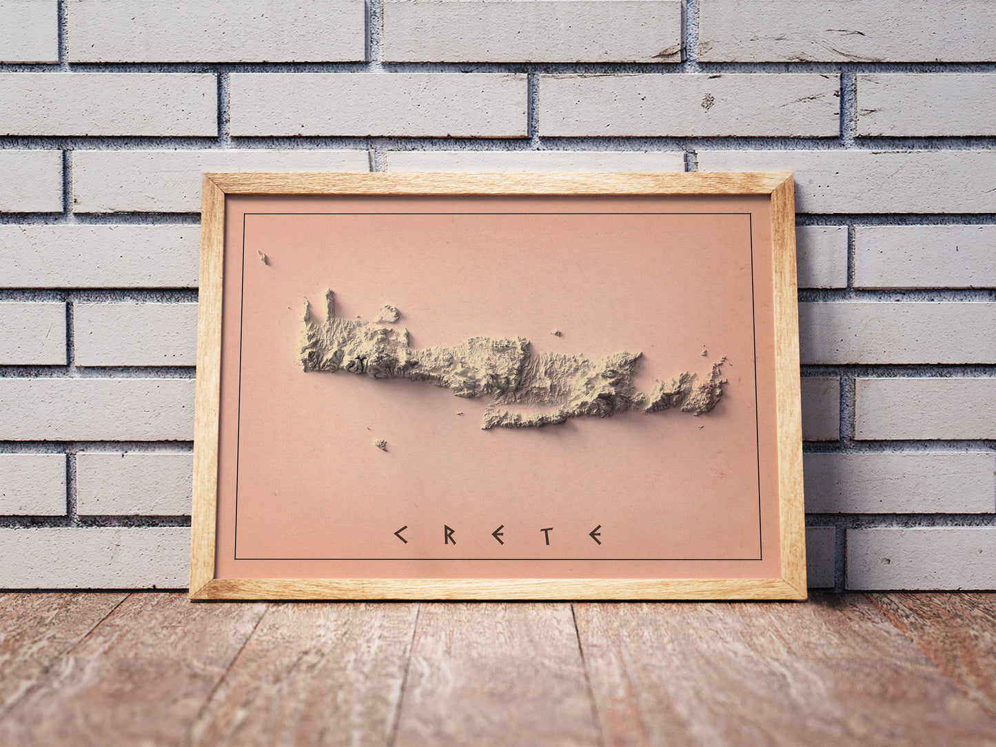 Vintage Crete, Greece, shaded relief map in a wooden frame. Realistic terrain art print for home decor, displayed against a brick wall