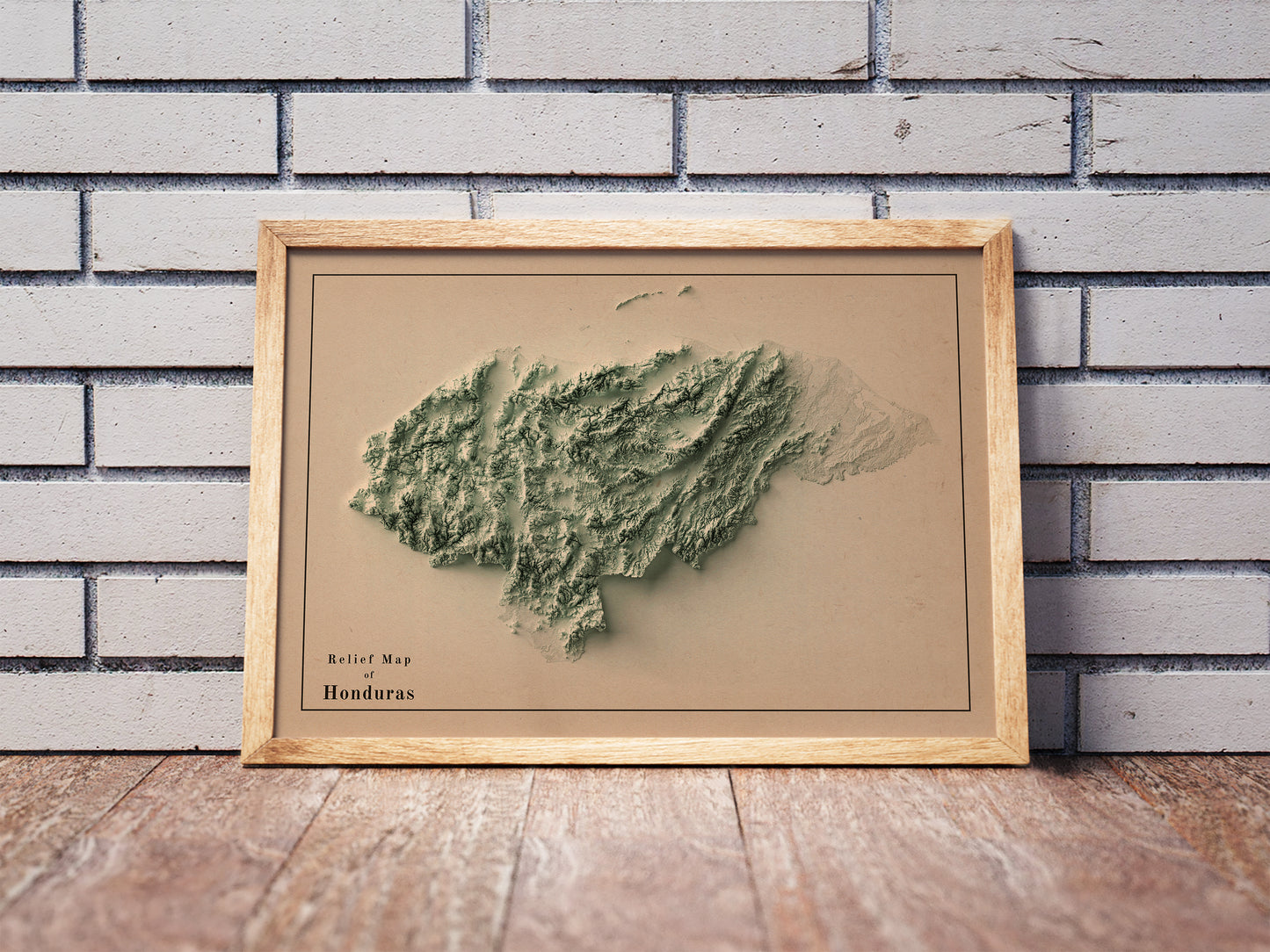 Vintage Honduras shaded relief map in a wooden frame. Realistic terrain art print for home decor, displayed against a brick wall