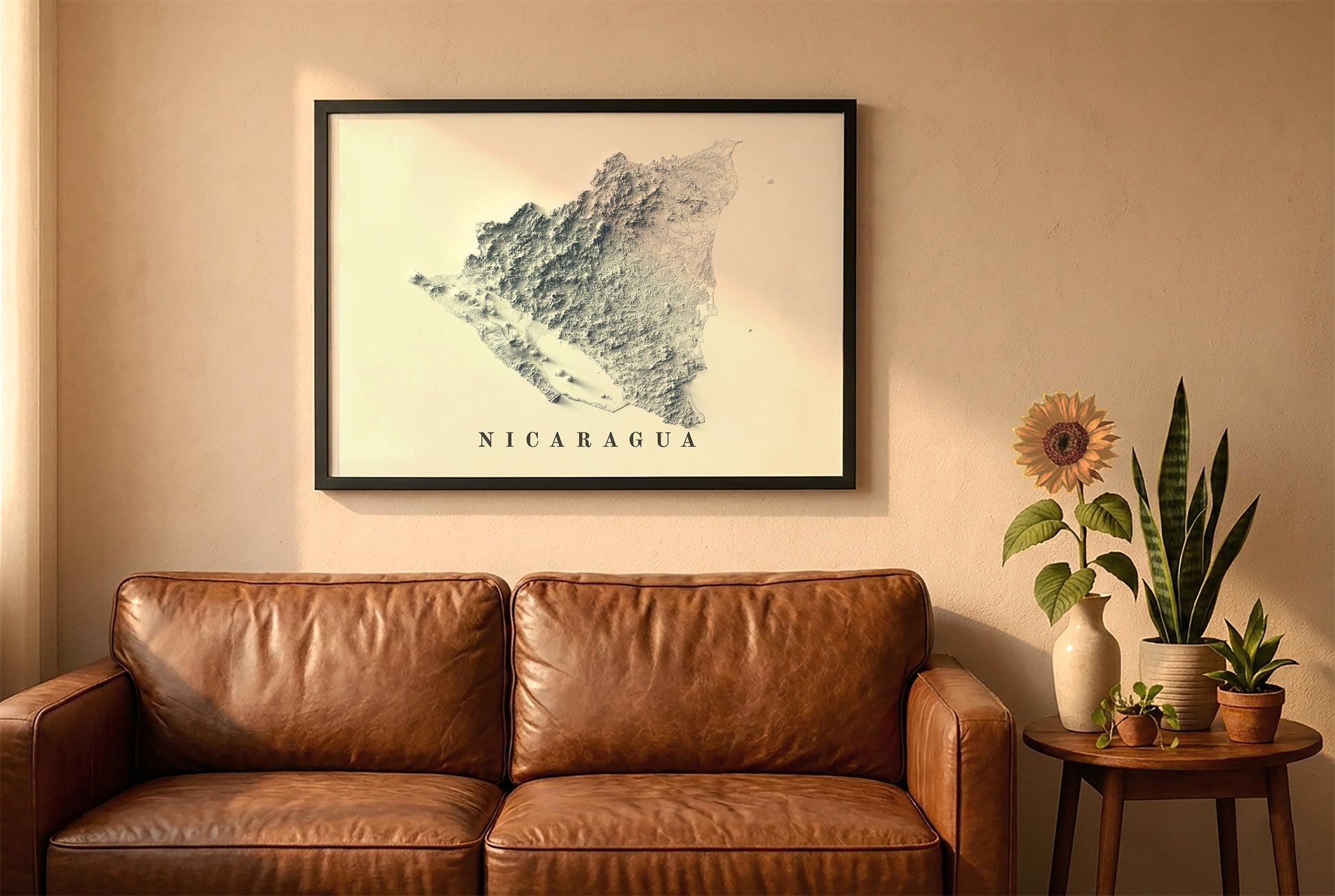 Nicaragua relief map in a black frame above a brown leather sofa. Boho living room with warm sunlight, sunflower, and indoor plants on a wooden side table