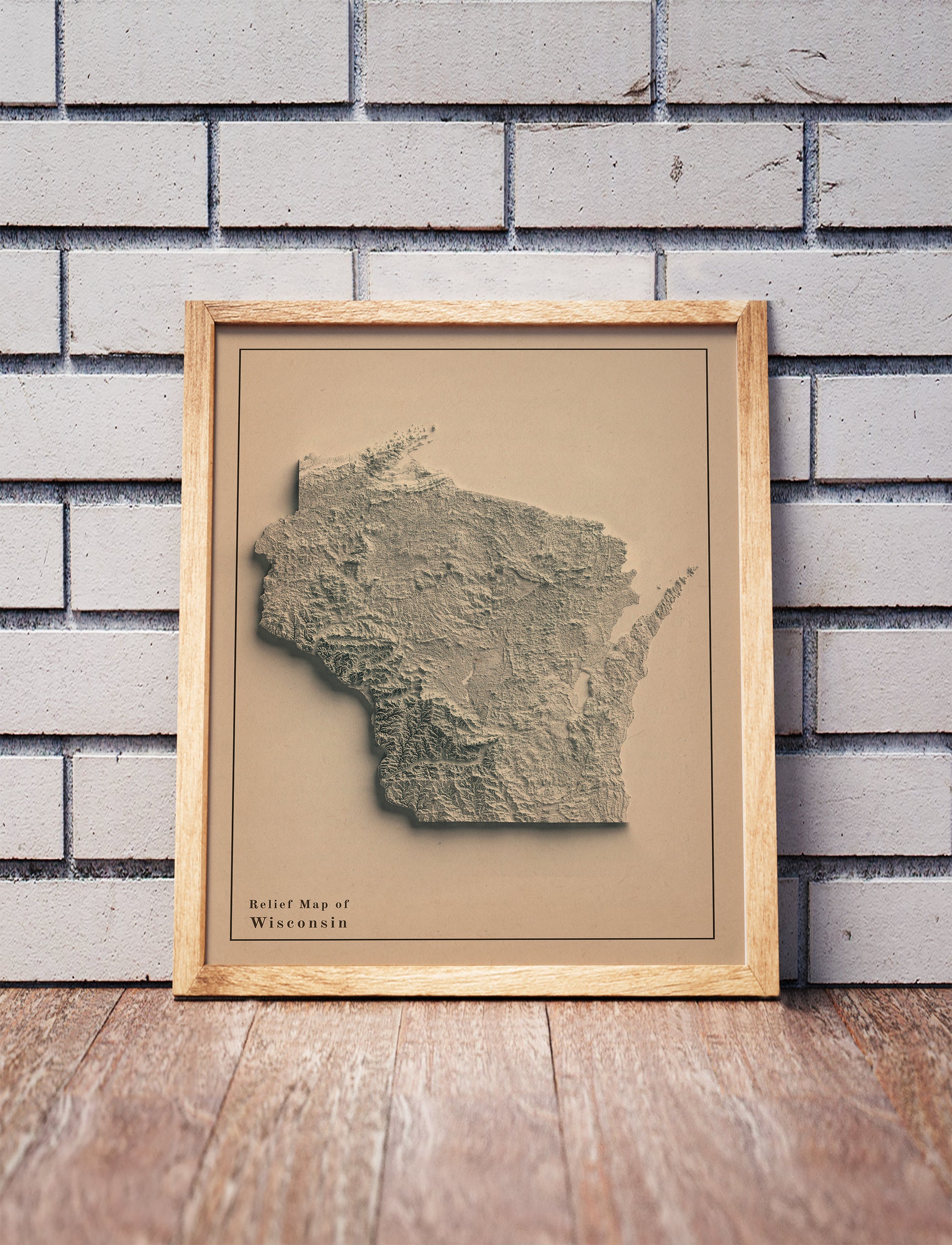 Vintage Wisconsin shaded relief map in a wooden frame. Realistic terrain art print for home decor, displayed against a brick wall