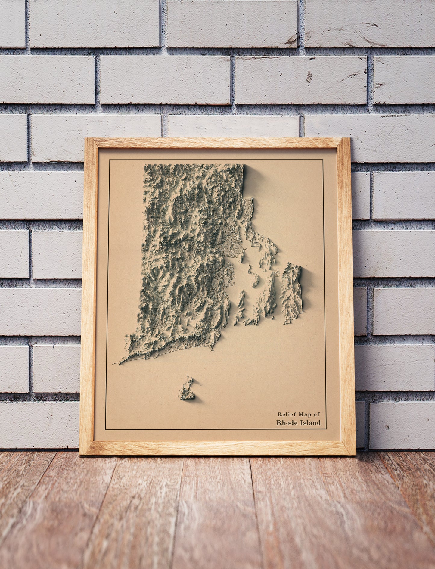 Vintage Rhode Island shaded relief map in a wooden frame. Realistic terrain art print for home decor, displayed against a brick wall