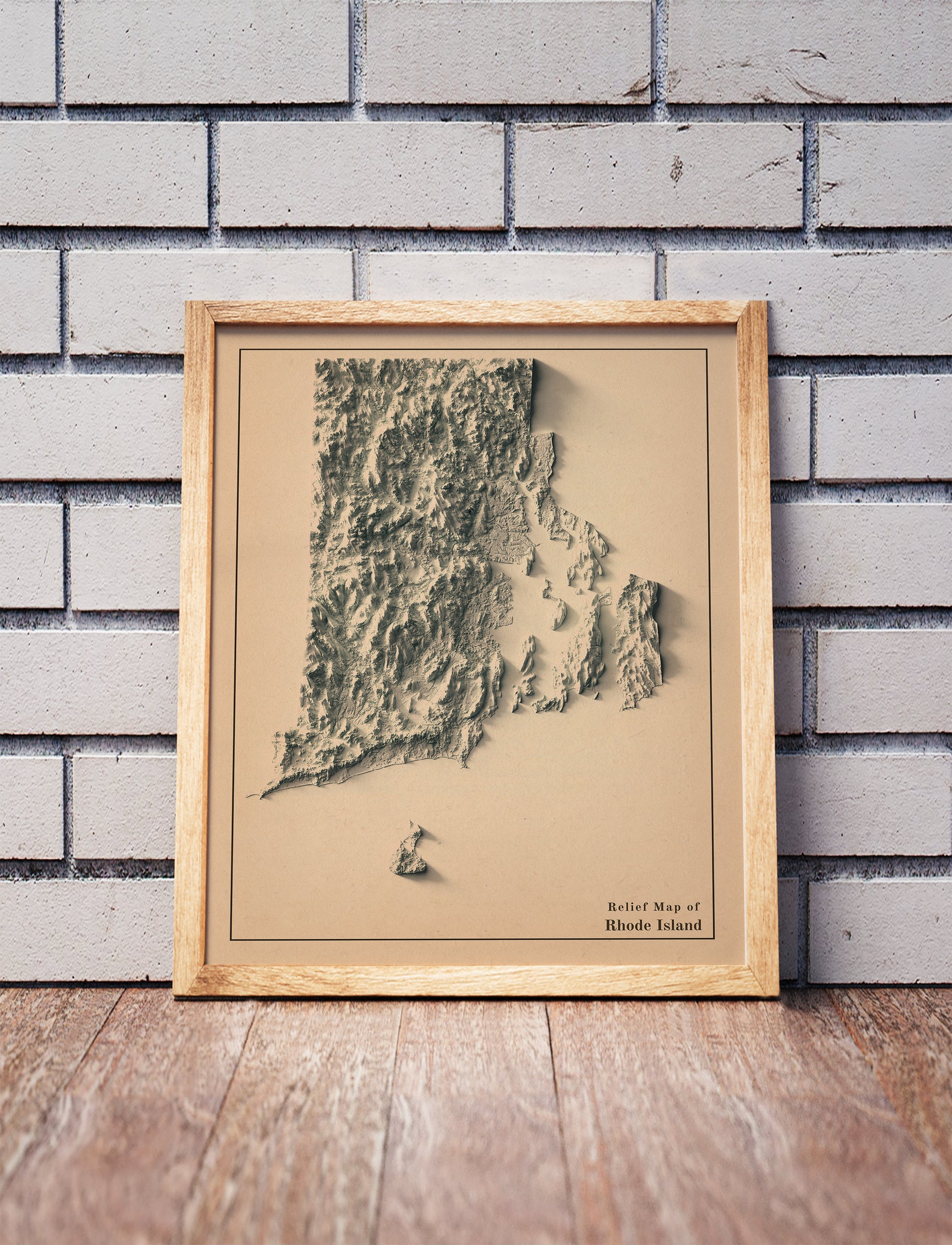 Vintage Rhode Island shaded relief map in a wooden frame. Realistic terrain art print for home decor, displayed against a brick wall