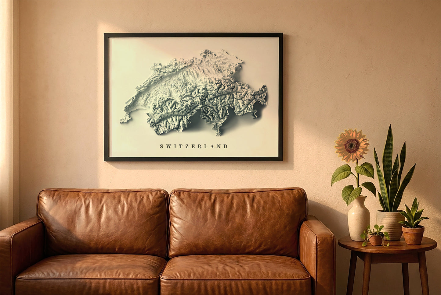 Switzerland relief map in a black frame above a brown leather sofa. Boho living room with warm sunlight, sunflower, and indoor plants on a wooden side table