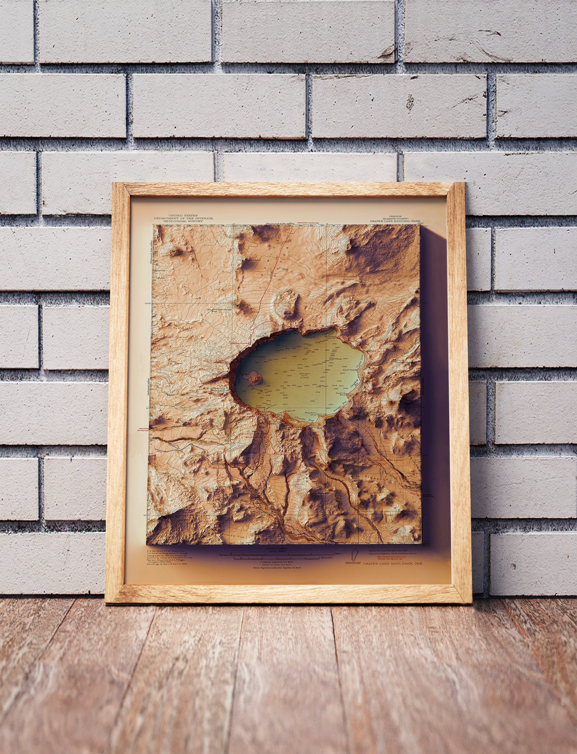Vintage Crater Lake, Oregon, shaded relief map in a wooden frame. Realistic terrain art print for home decor, displayed against a brick wall