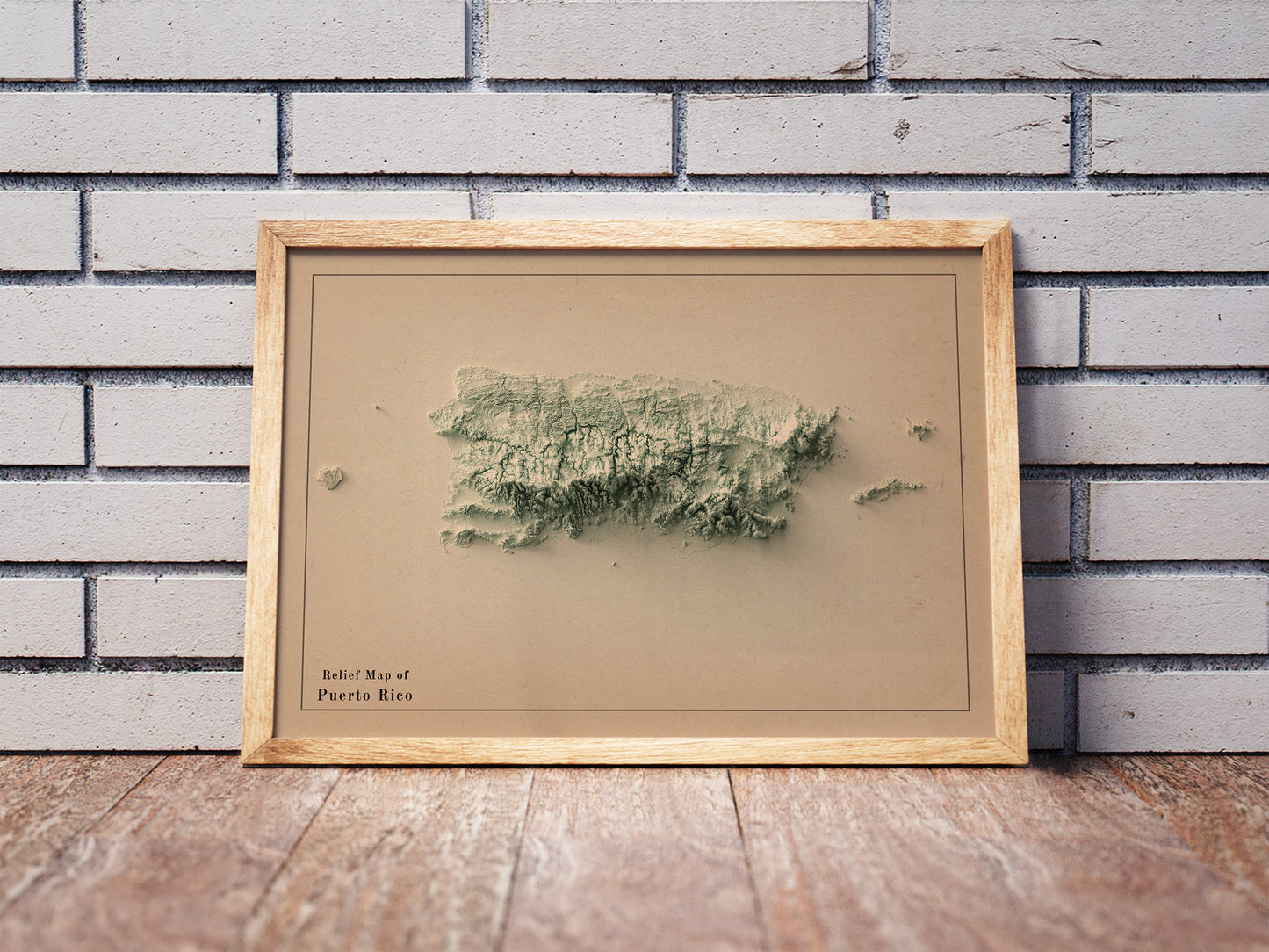 Vintage Puerto Rico shaded relief map in a wooden frame. Realistic terrain art print for home decor, displayed against a brick wall