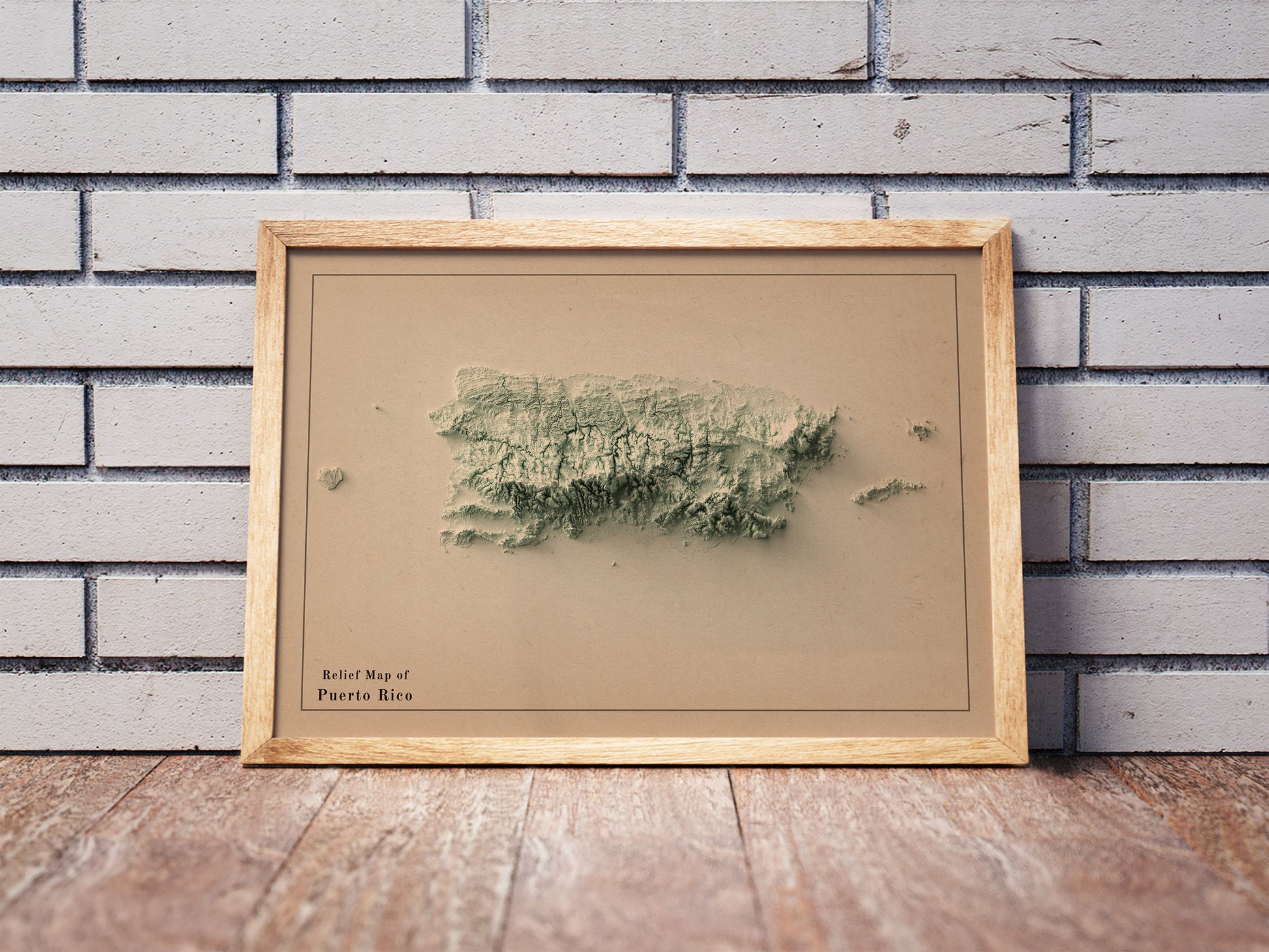 Vintage Puerto Rico shaded relief map in a wooden frame. Realistic terrain art print for home decor, displayed against a brick wall