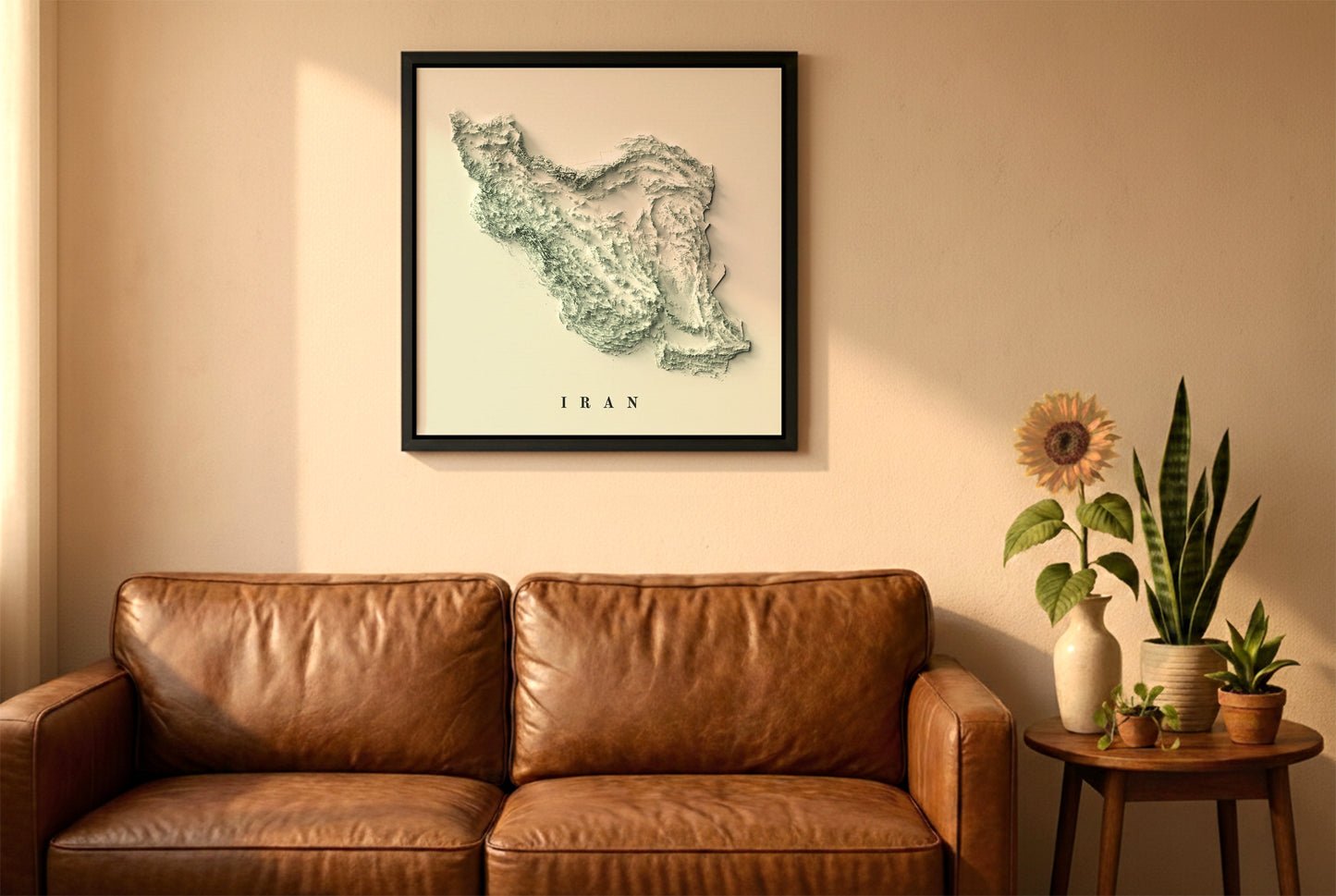 Iran relief map in a black frame above a brown leather sofa. Boho living room with warm sunlight, sunflower, and indoor plants on a wooden side table