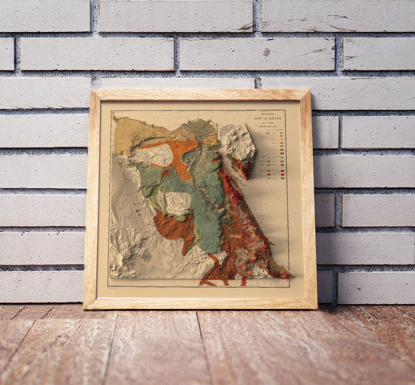 Vintage Egypt shaded relief map in a wooden frame. Realistic terrain art print for home decor, displayed against a brick wall