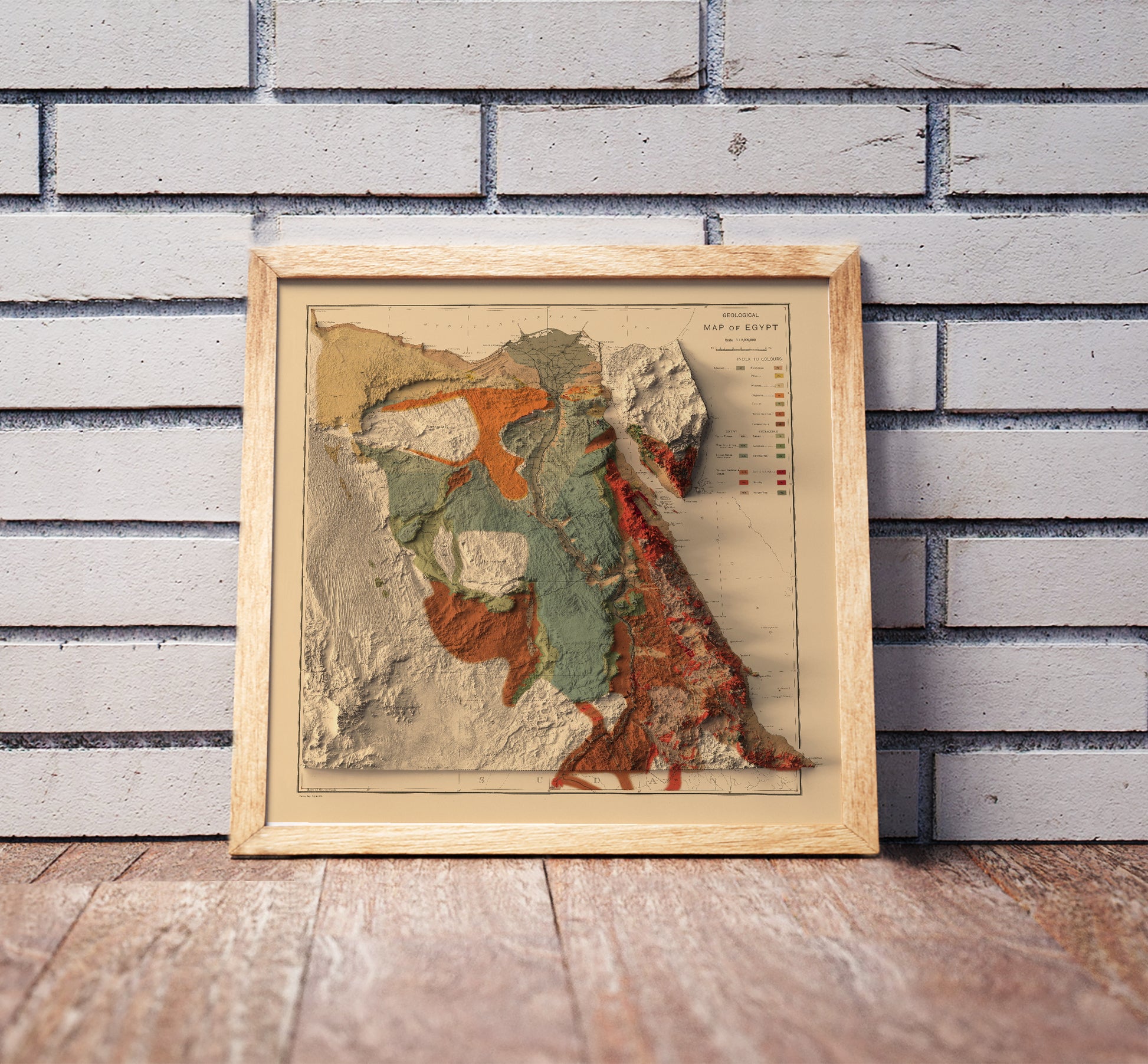 Vintage Egypt shaded relief map in a wooden frame. Realistic terrain art print for home decor, displayed against a brick wall